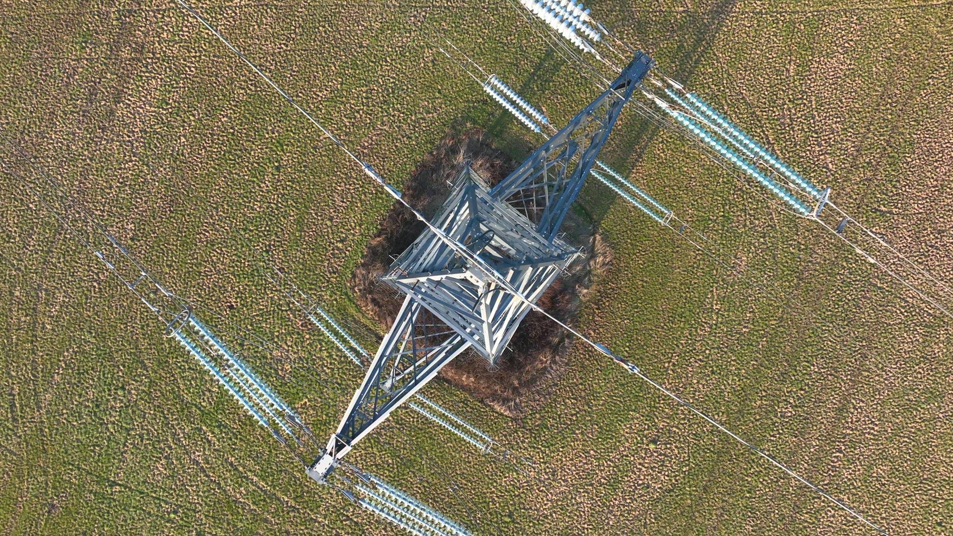 Bird's Eye View of Industrial High Voltage Lattice Power Line Tower