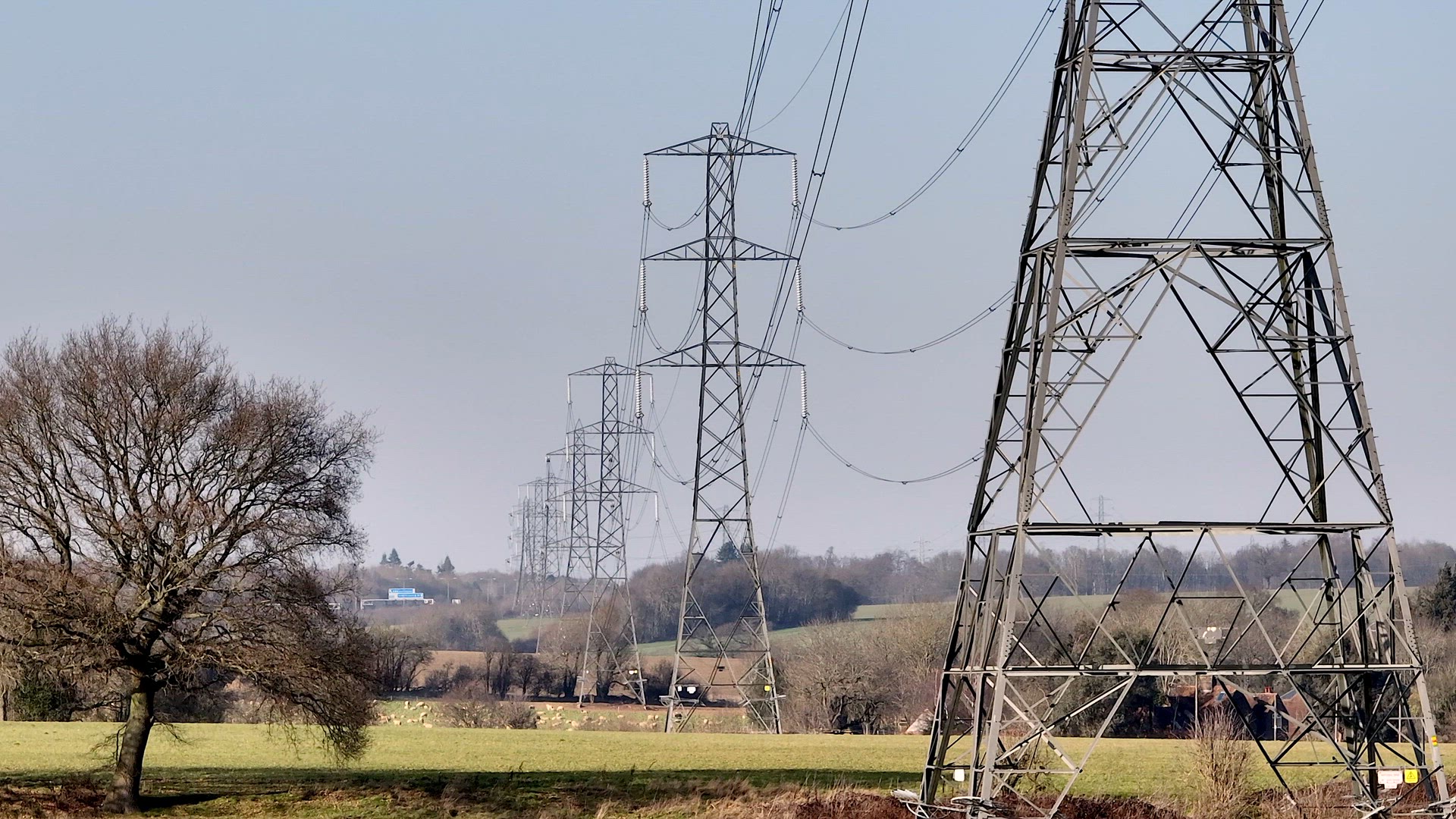 Rows of Lattice Power Line Towers Aerial View