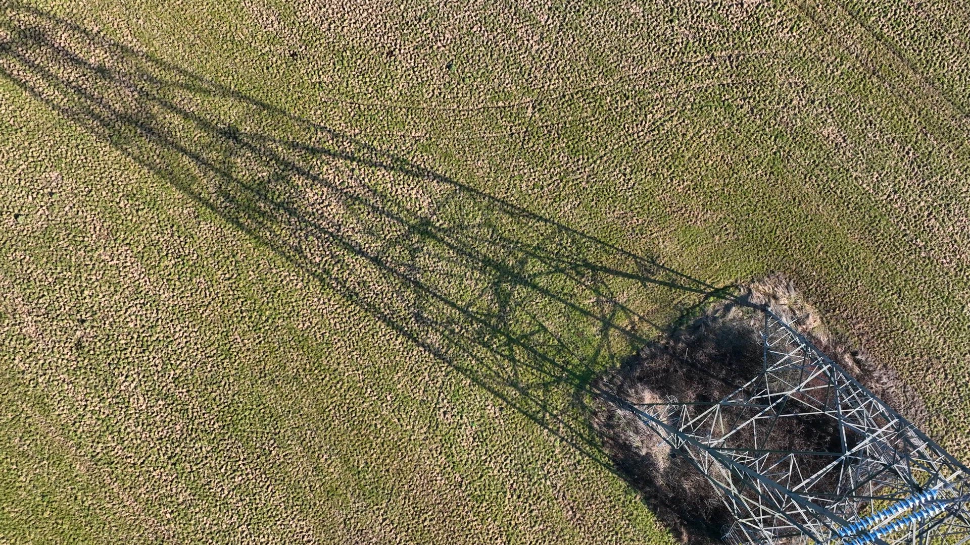 Bird's Eye View of Industrial High Voltage Lattice Power Line Tower