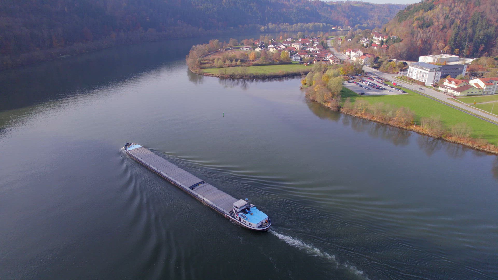 Cargo Pusher Boat on a River Transporting Cargo and Goods Along a River Bend