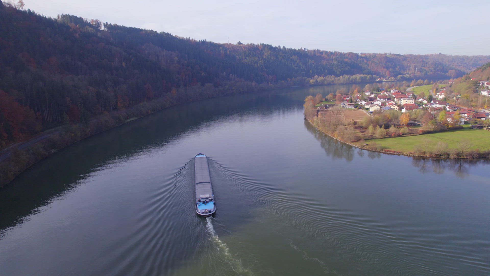 Cargo Pusher Boat on a River Transporting Cargo and Goods Along a River Bend