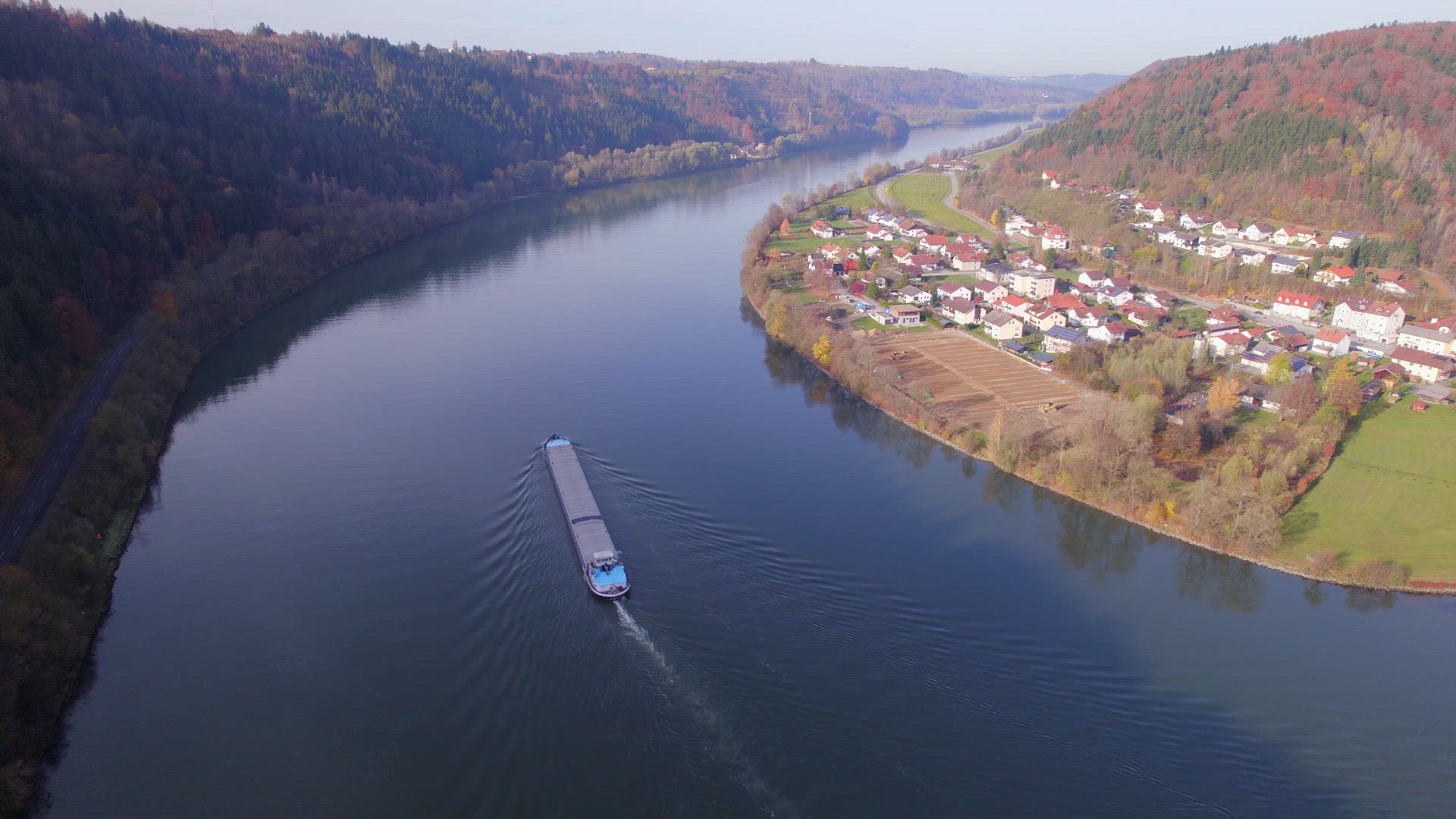 Cargo Pusher Boat on a River Transporting Cargo and Goods Along a Autumnal River