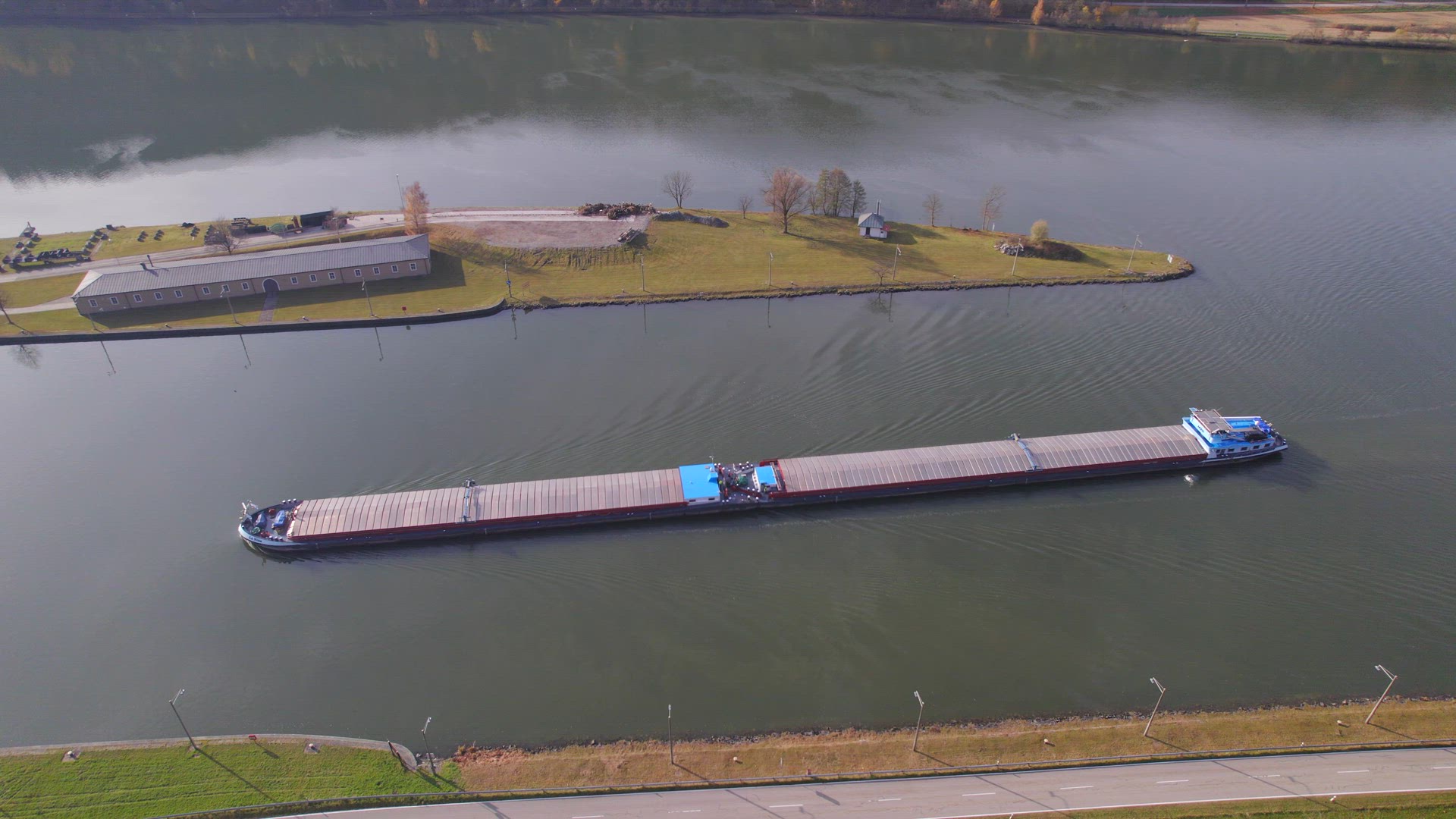 Cargo Pusher Boat on a River Transporting Cargo and Goods Along a Autumnal River