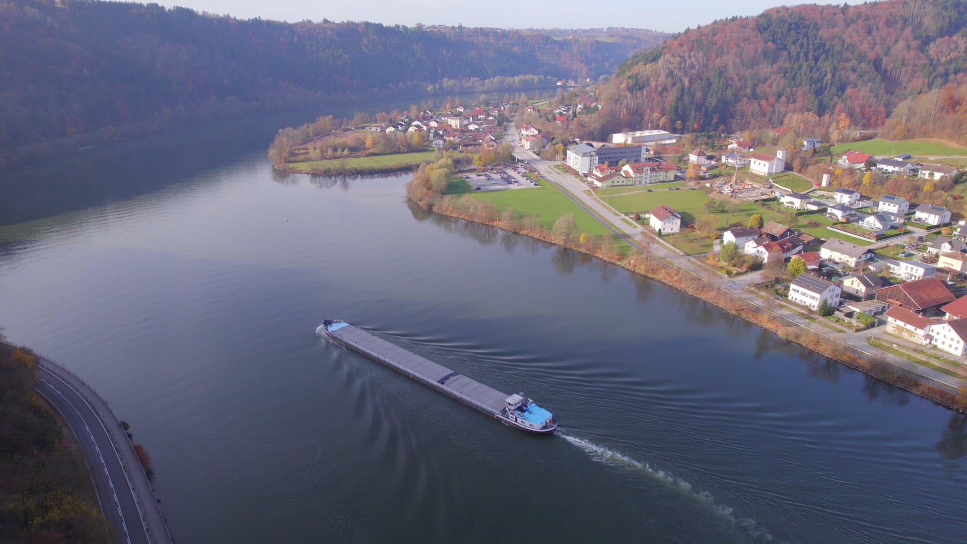Cargo Pusher Boat on a River Transporting Cargo and Goods Along a River Bend