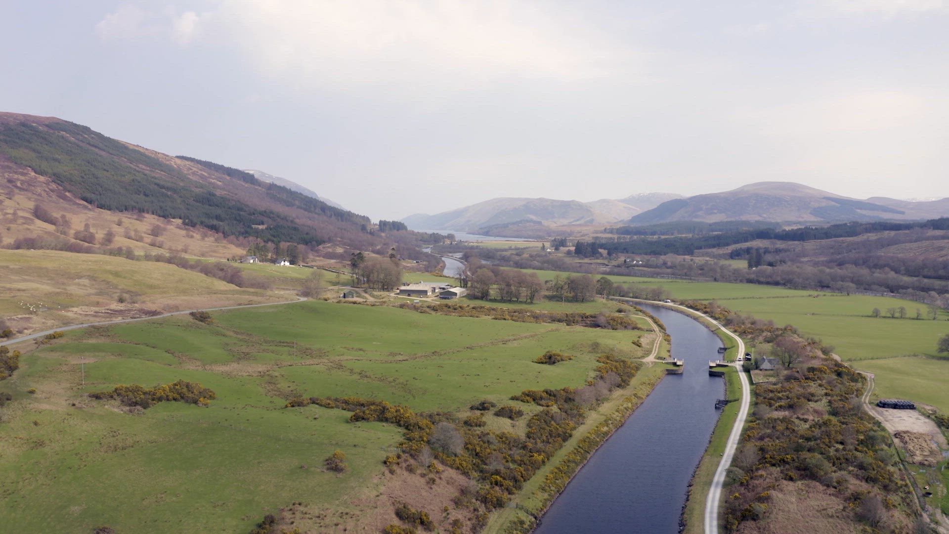 A Luxury Sailing Yacht Motoring Along a Canal with Beautiful Landscape