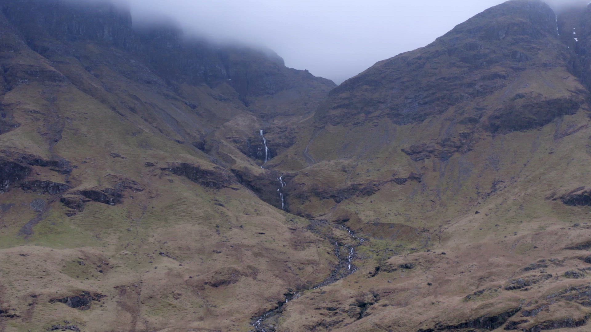 The Glencoe Valley and a Small House Surrounded by Mountains in the Highlands