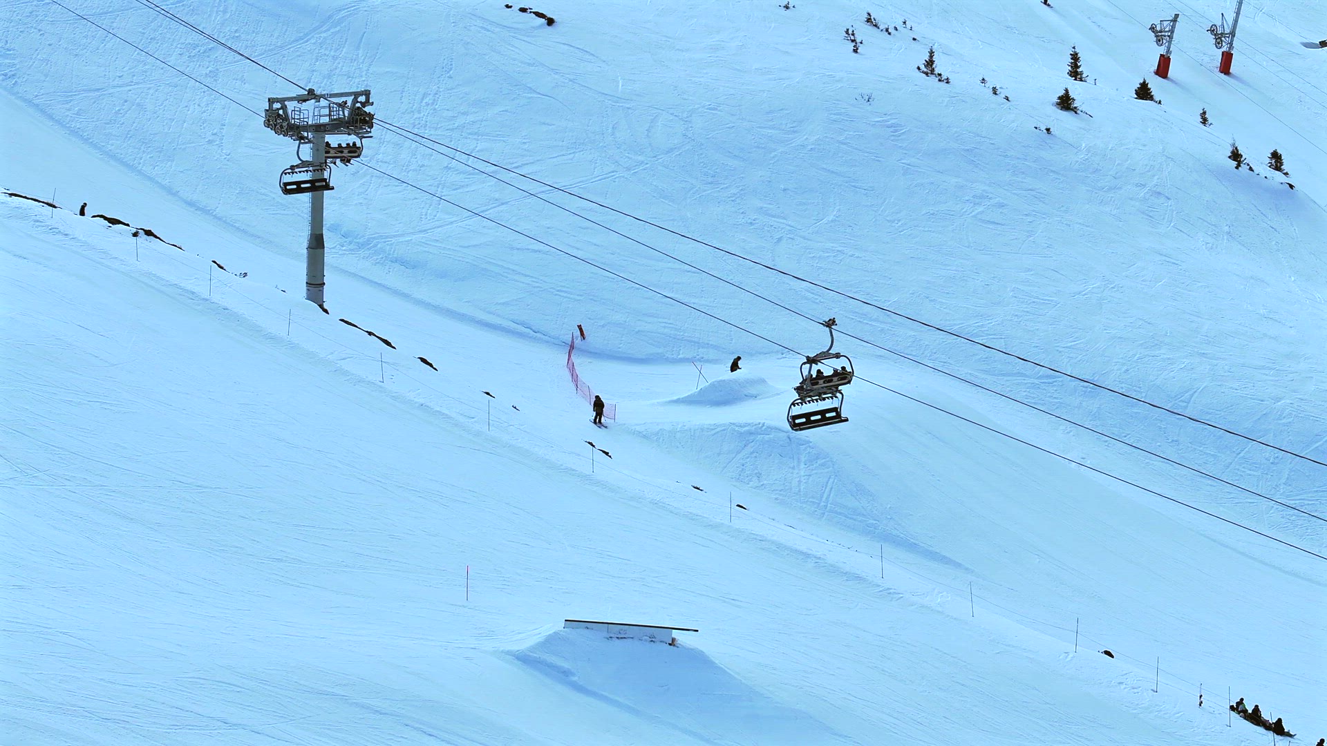 Skiers and Snowboarders Using a Chairlift To Ascend a Mountain