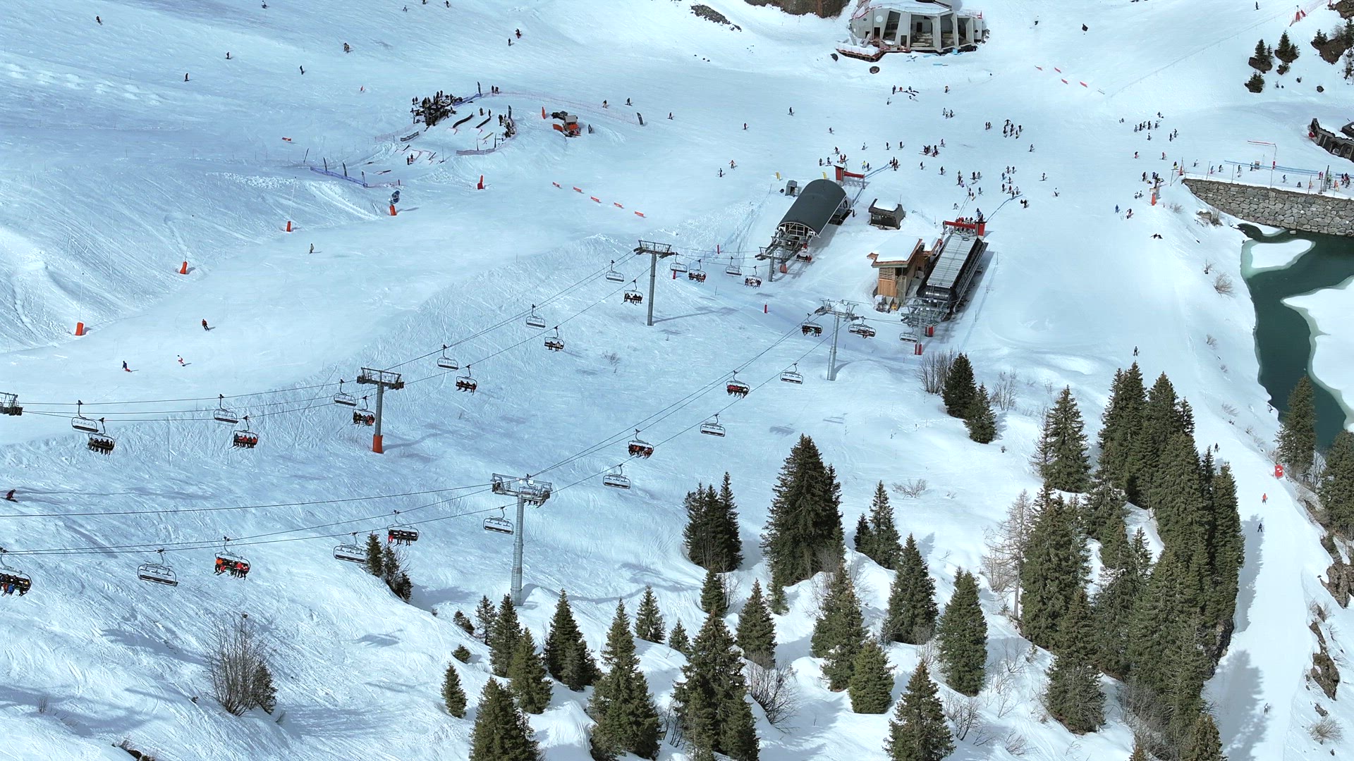 Skiers and Snowboarders Using a Chairlift To Ascend a Mountain