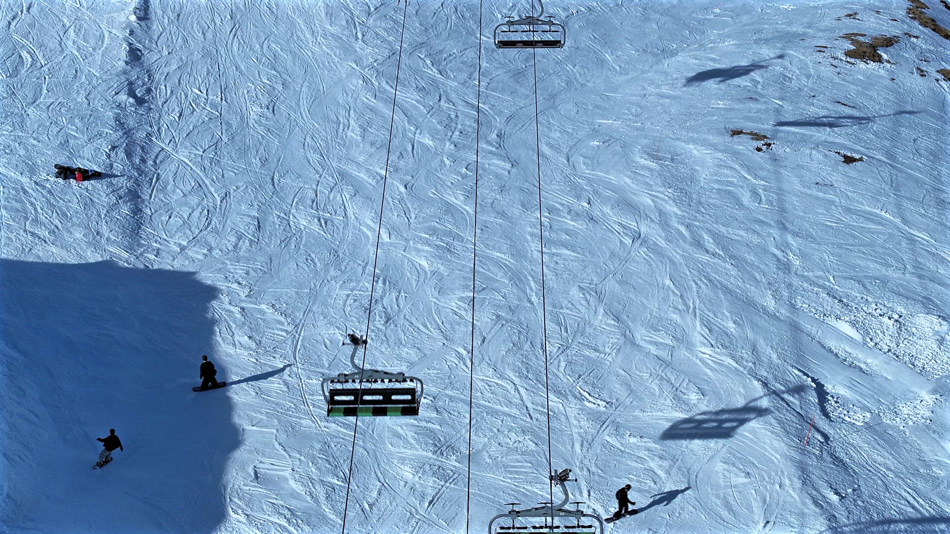Skiers and Snowboarders Using a Chairlift To Ascend a Mountain