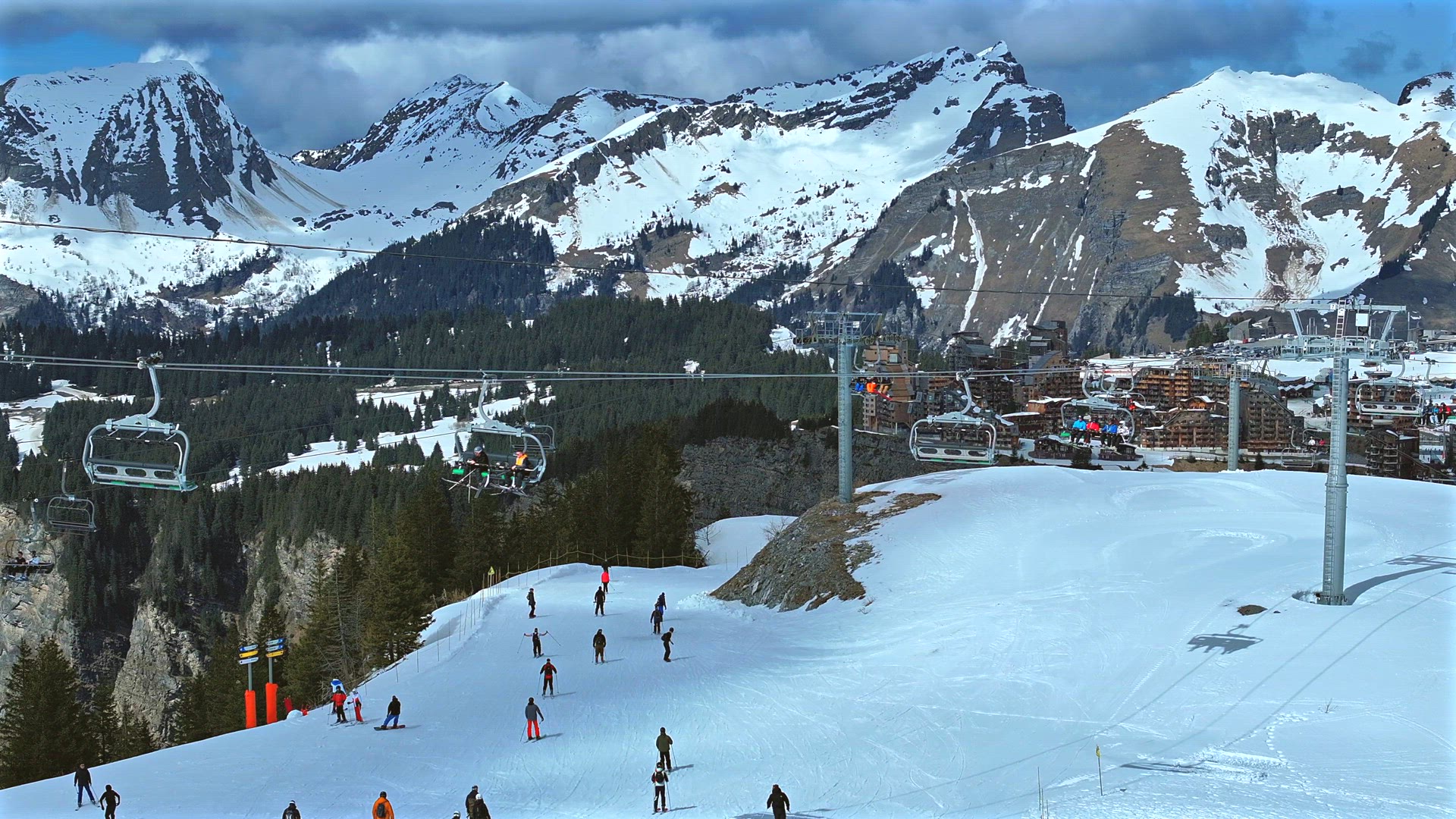 Skiers and Snowboarders Using a Chairlift To Ascend a Mountain