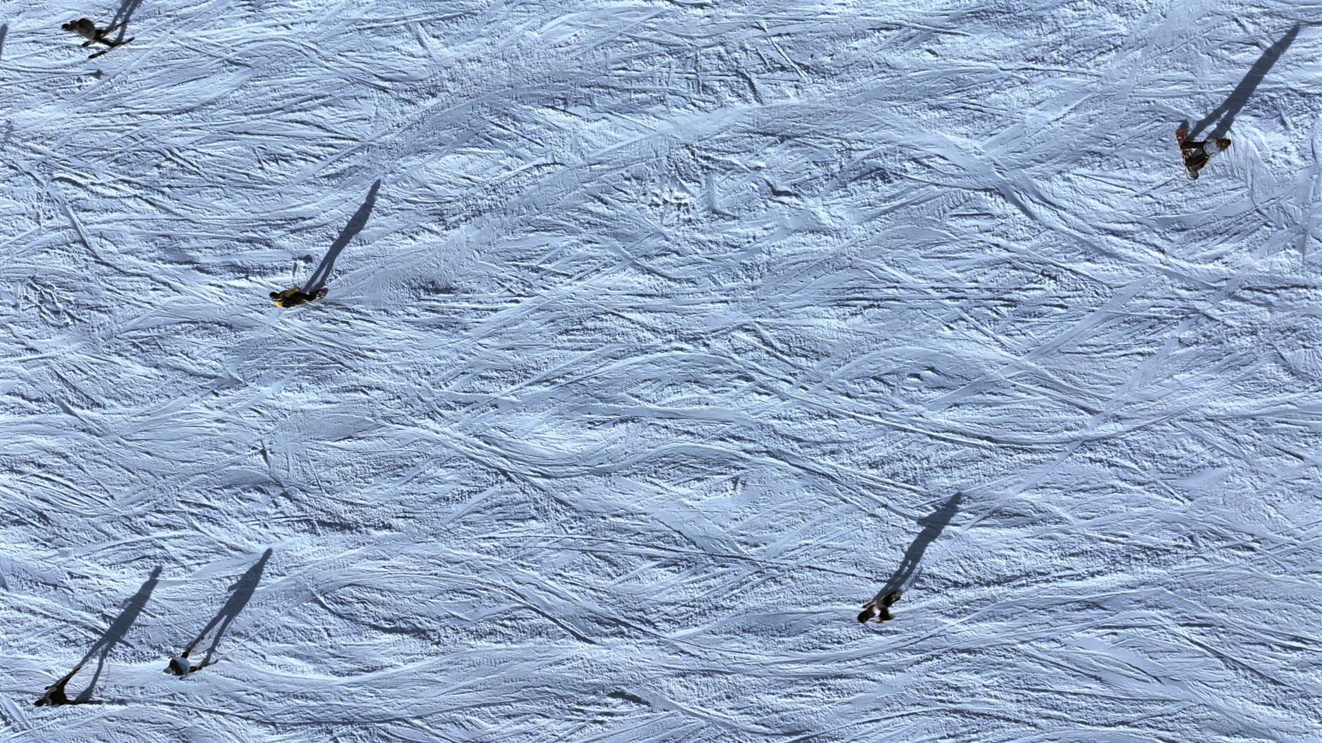 Abstract Aerial View of Skiers on a Slope With Shadows