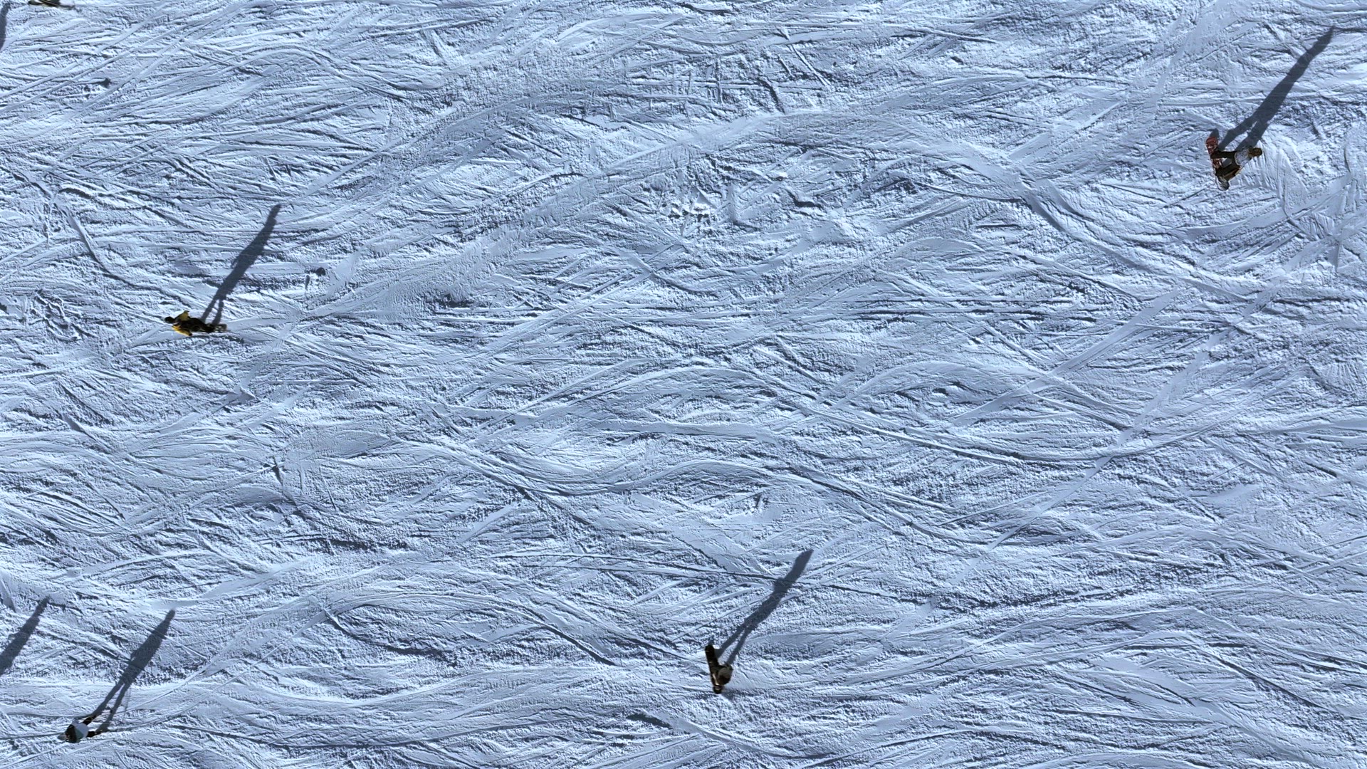 Abstract Aerial View of Skiers on a Slope With Shadows