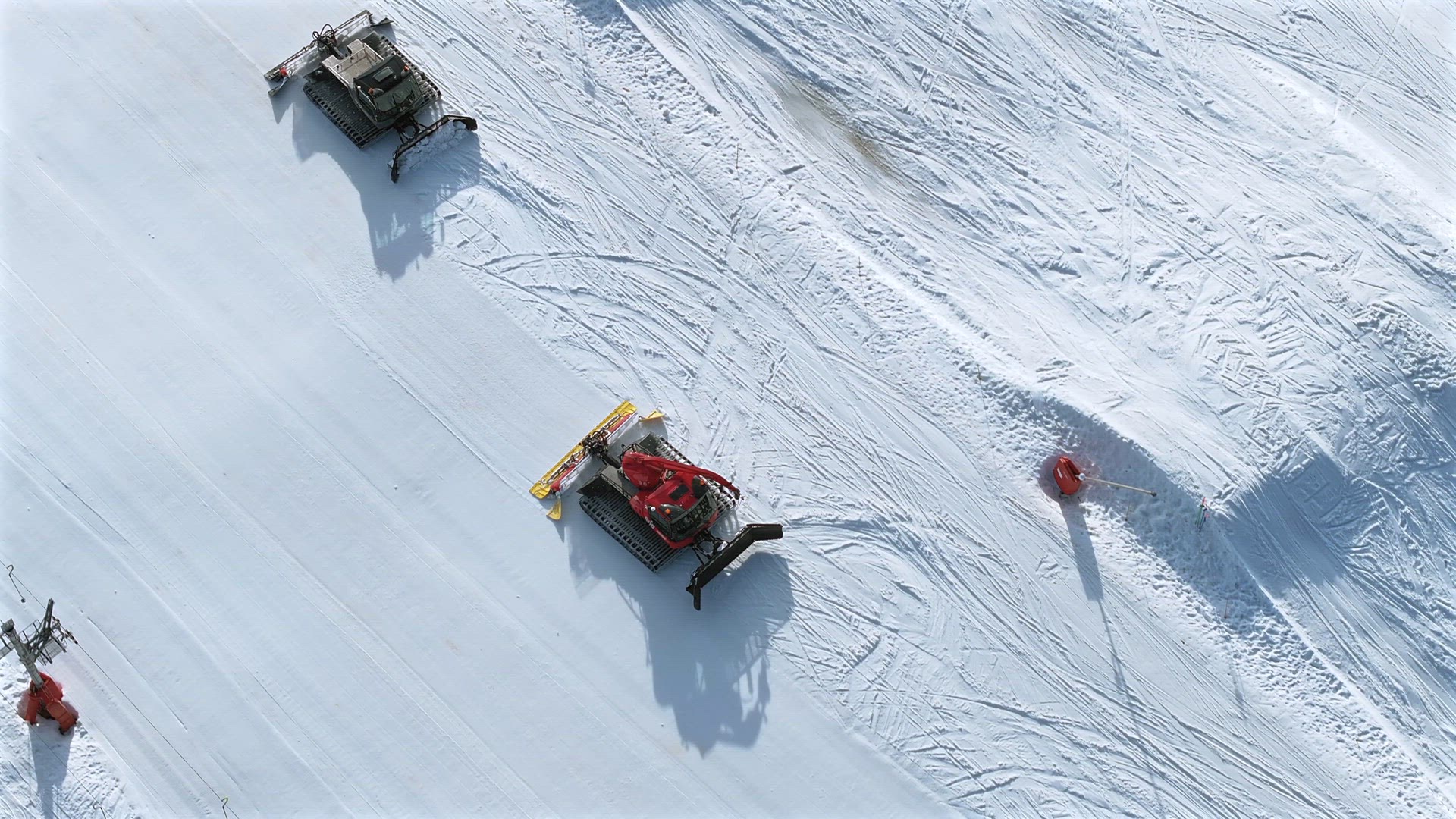 Snow Groomer and Piste Basher Working on a Ski Piste Aerial View