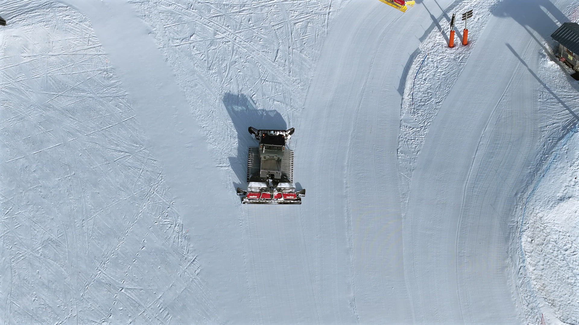 Snow Groomer and Piste Basher Working on a Ski Piste Aerial View