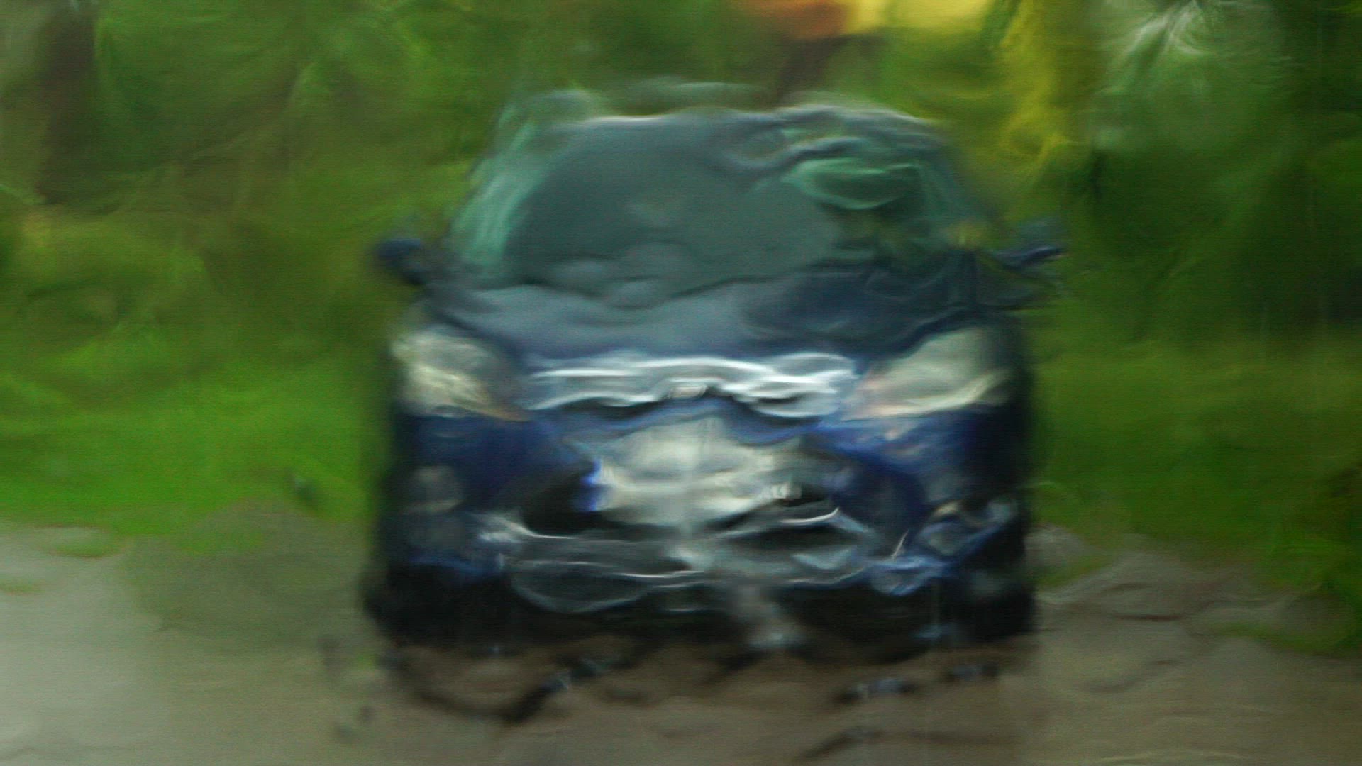 heavy rain on cars windshield - slomo - car in background.mp4