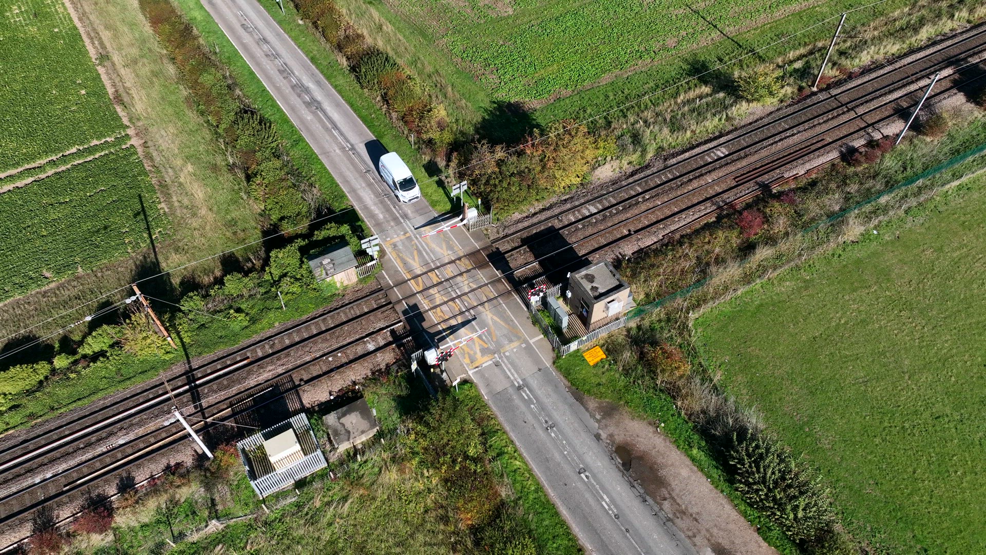 Cargo Train Passing Over a Level Crossing with Vehicles