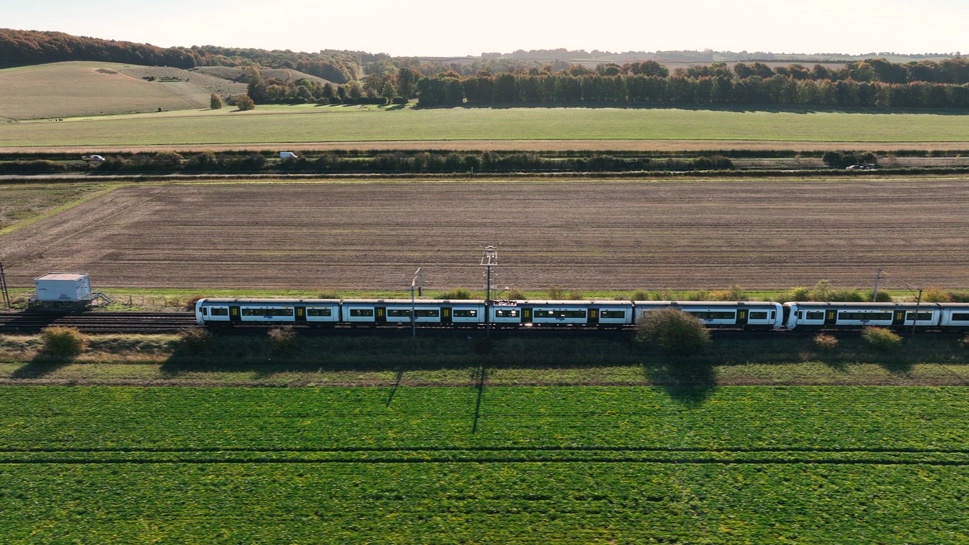 Fast Commuter Train Passing Over a Level Crossing with Vehicles