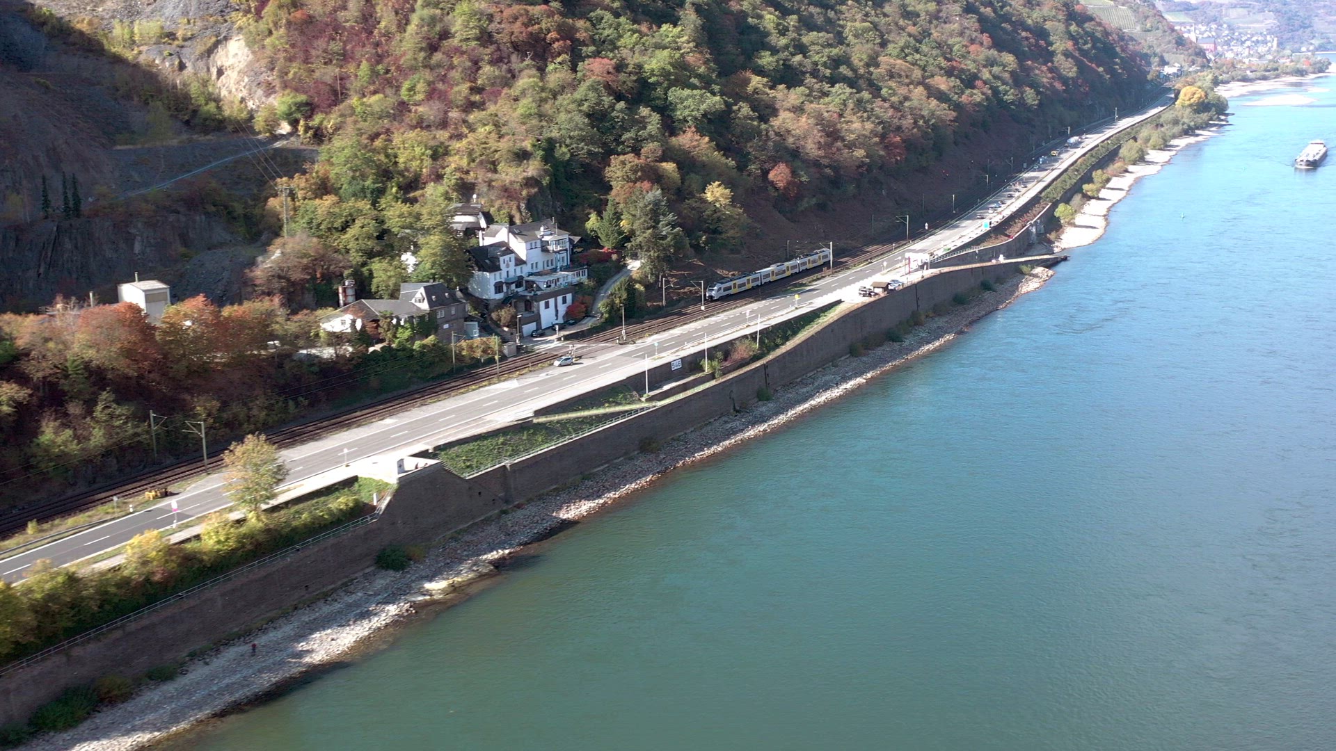 Commuter Train Passing Through a River Valley