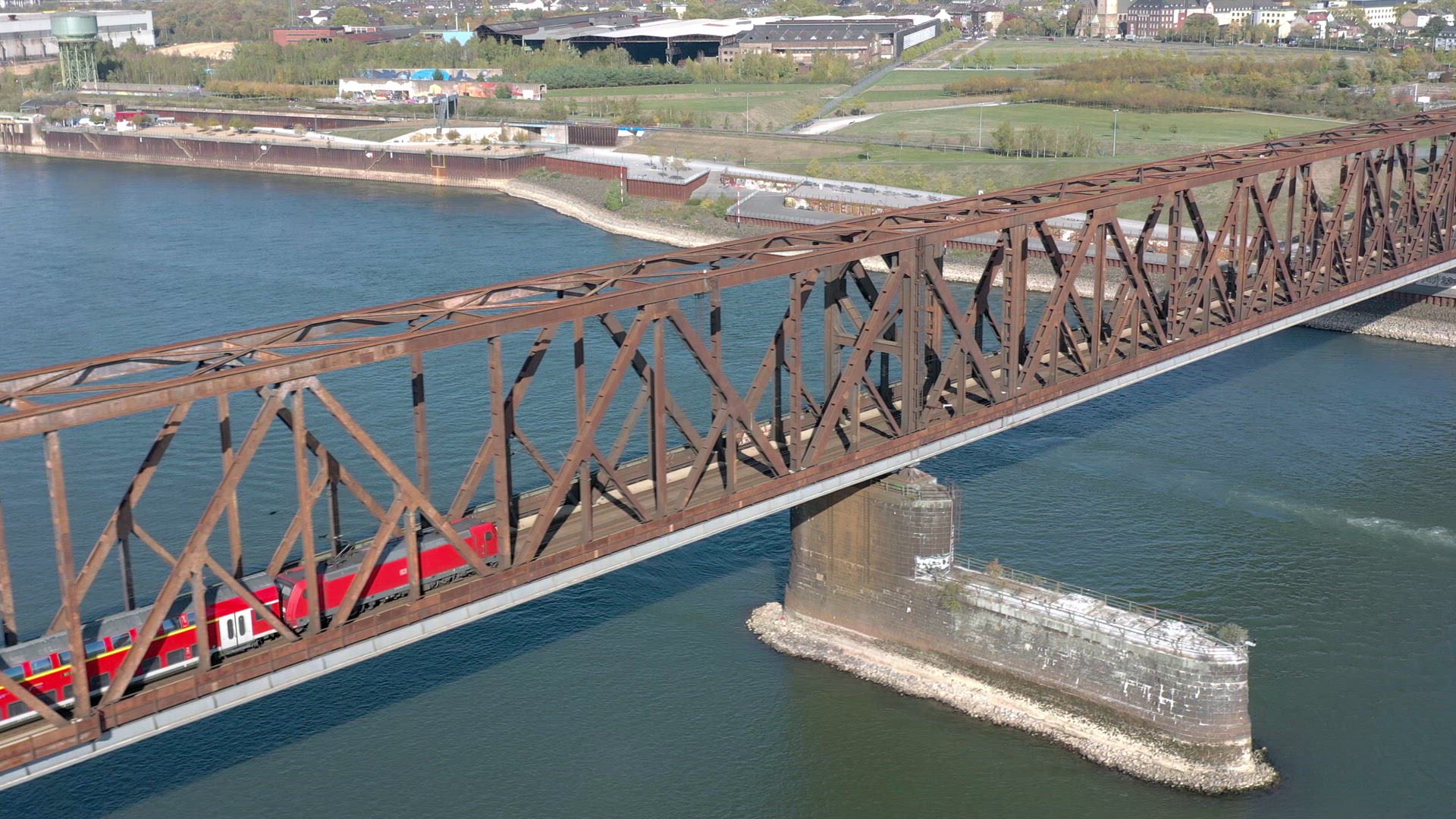Commuter Train Passing Over an Old Iron Bridge