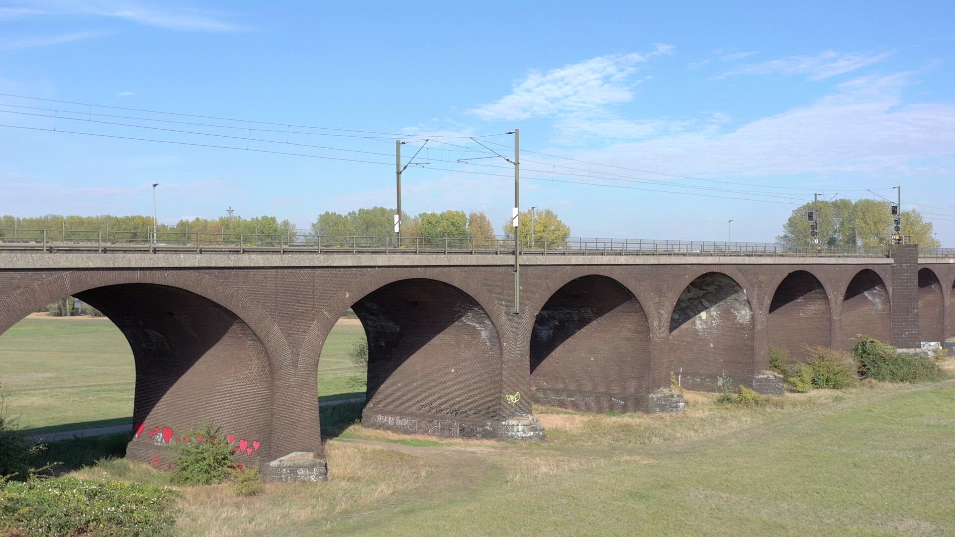 Commuter Train Passing Fast Over an Old Bridge