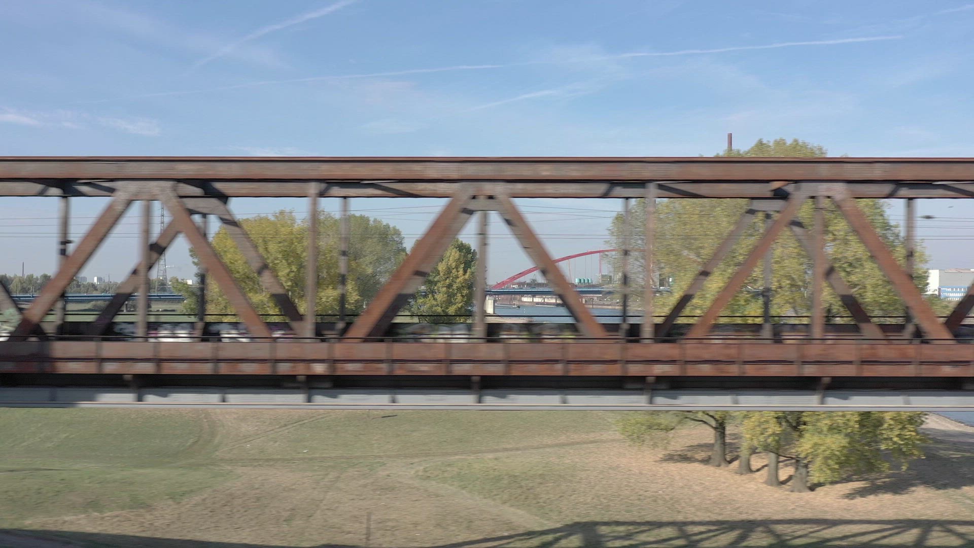 Commuter Train Passing Fast Over an Old Iron Bridge