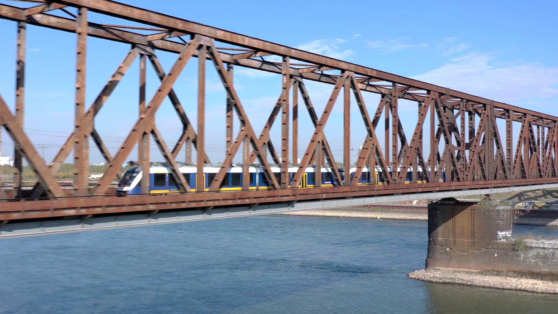 Commuter Train Passing Fast Over an Old Iron Bridge