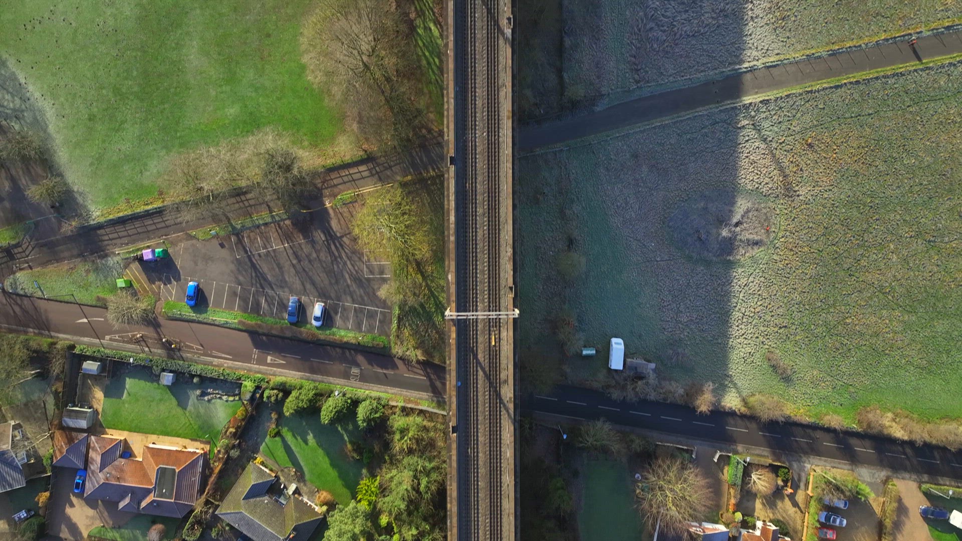 Fast Commuter Train Passing Over a Viaduct Bird's Eye View