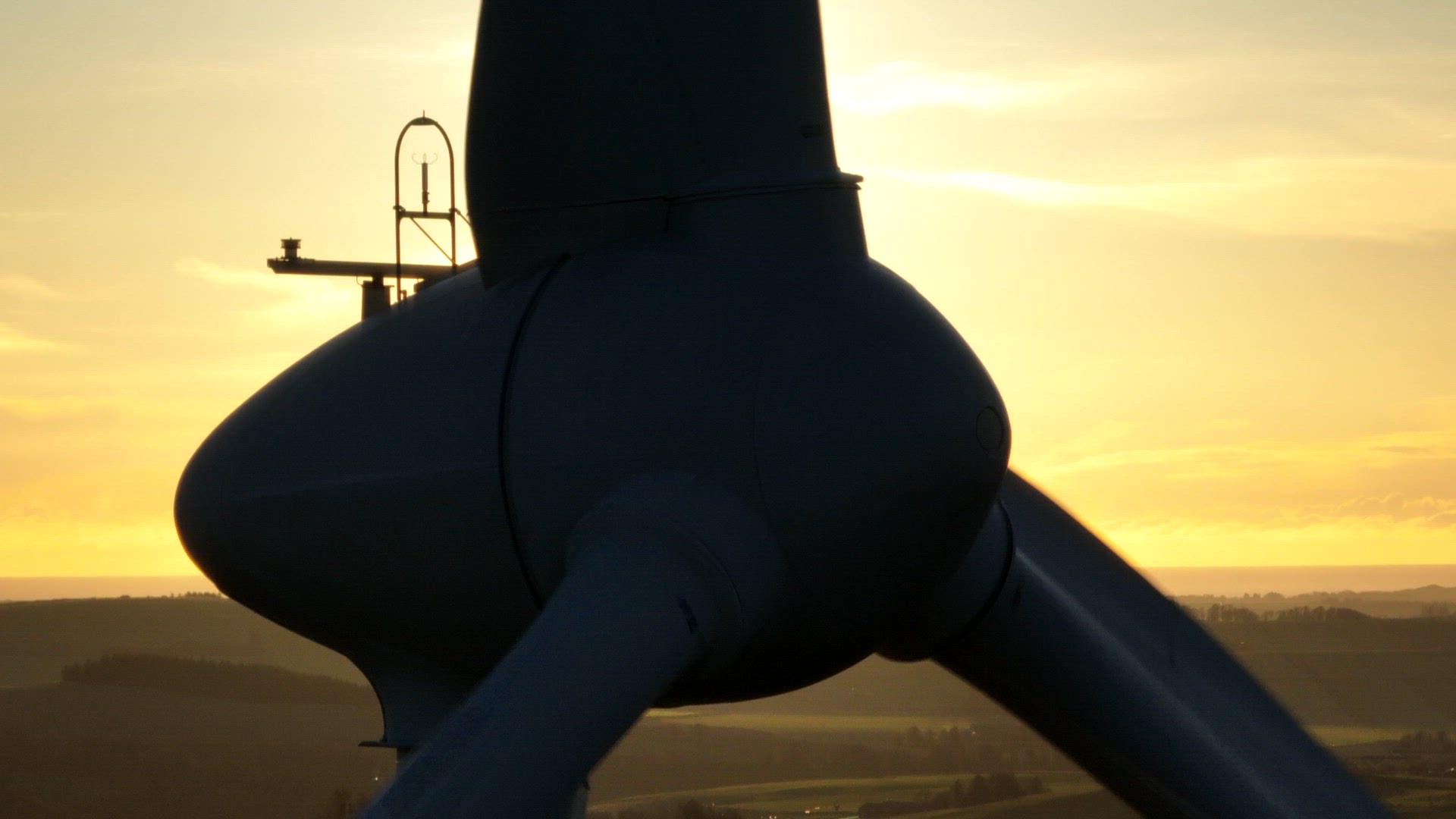 Wind Turbine Silhouette at Sunset Generating Renewable Energy