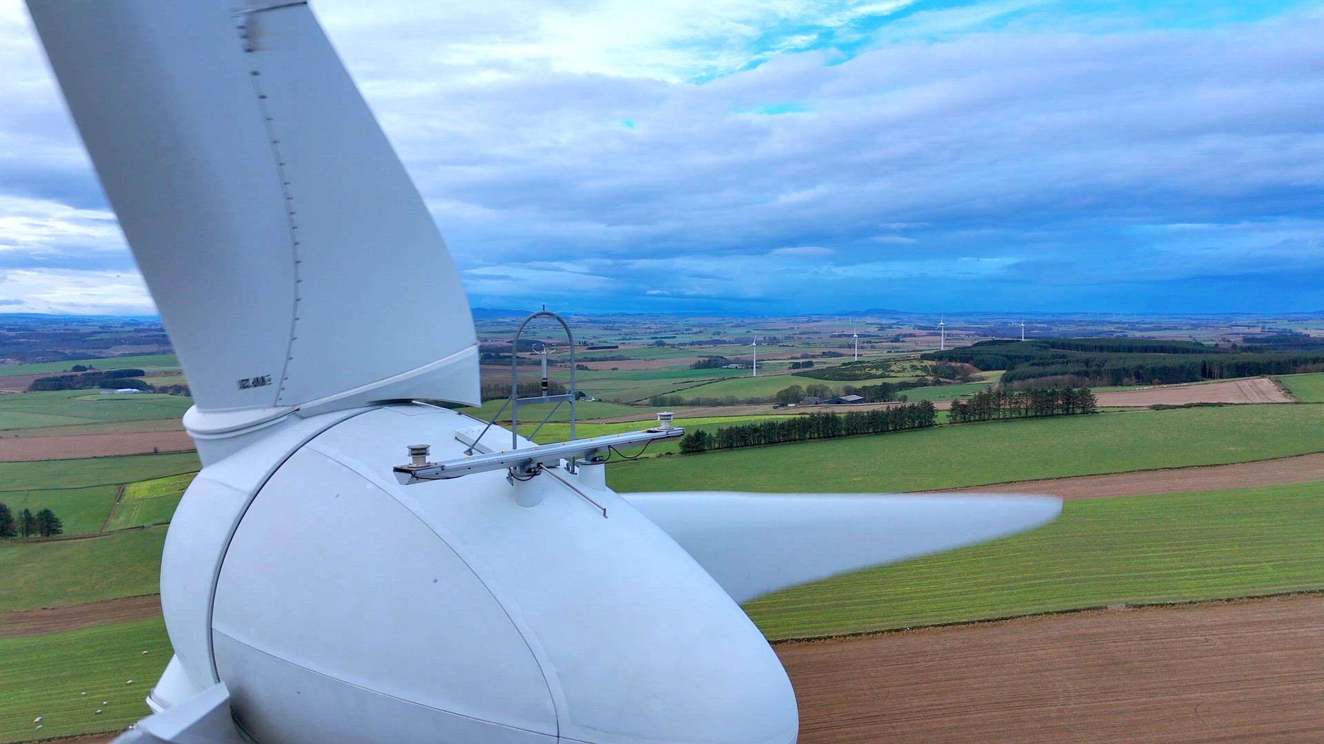 Close Up Aerial View of a Large Wind Farm Turbine