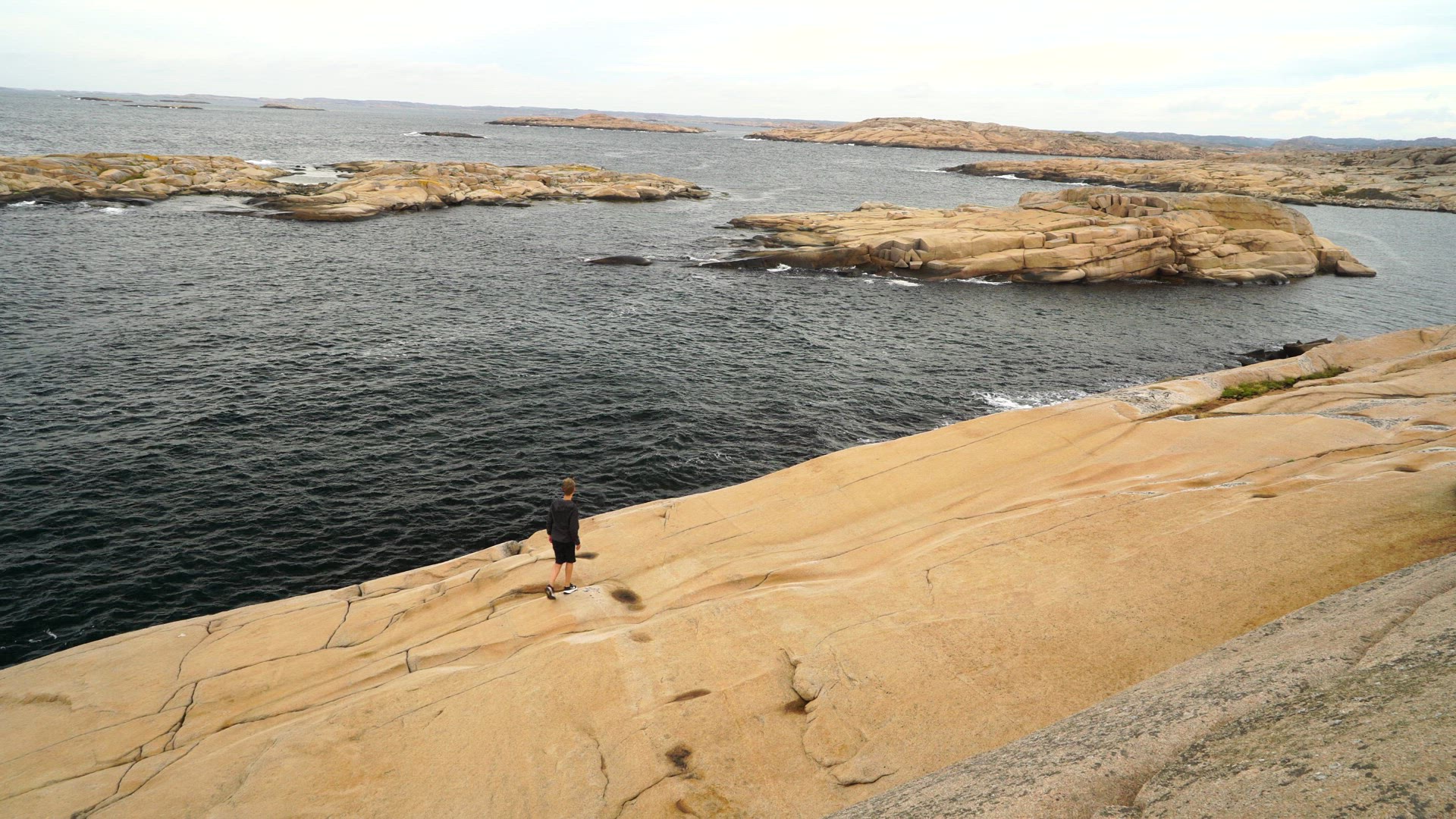 ramsvikslandet - boy walking on cliffs near sea - 1.mp4
