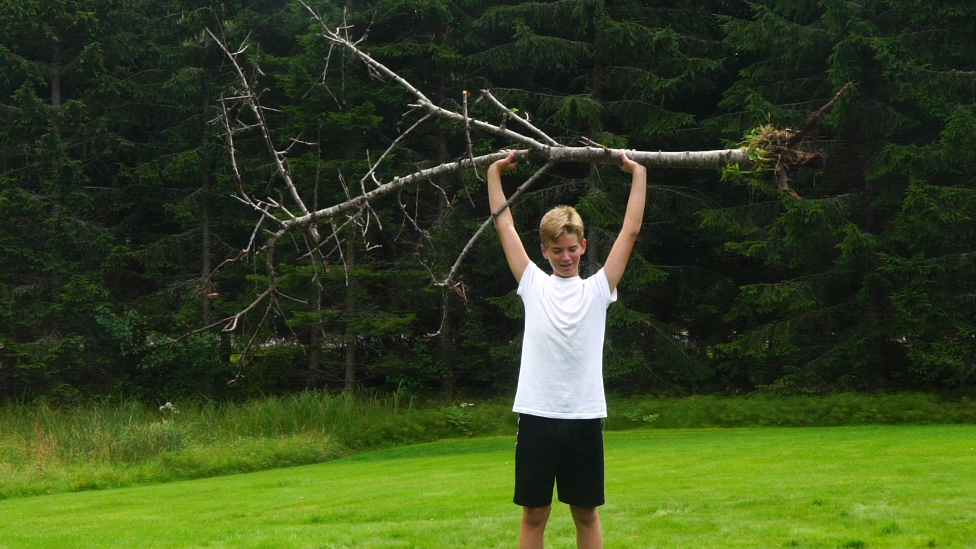strong boy lifting tree - slomo.mp4