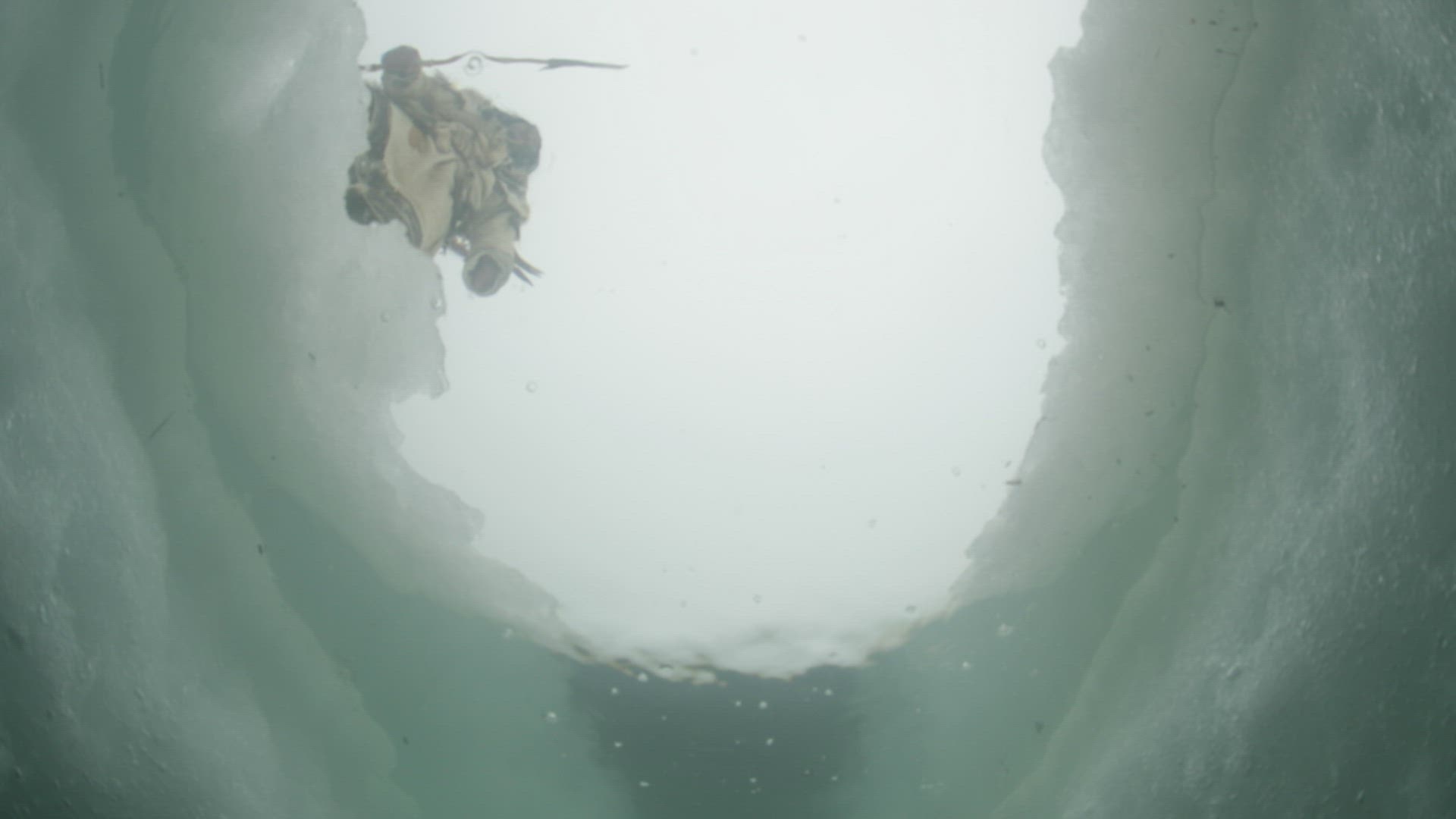 Inuit hunter jumping over arctic ice