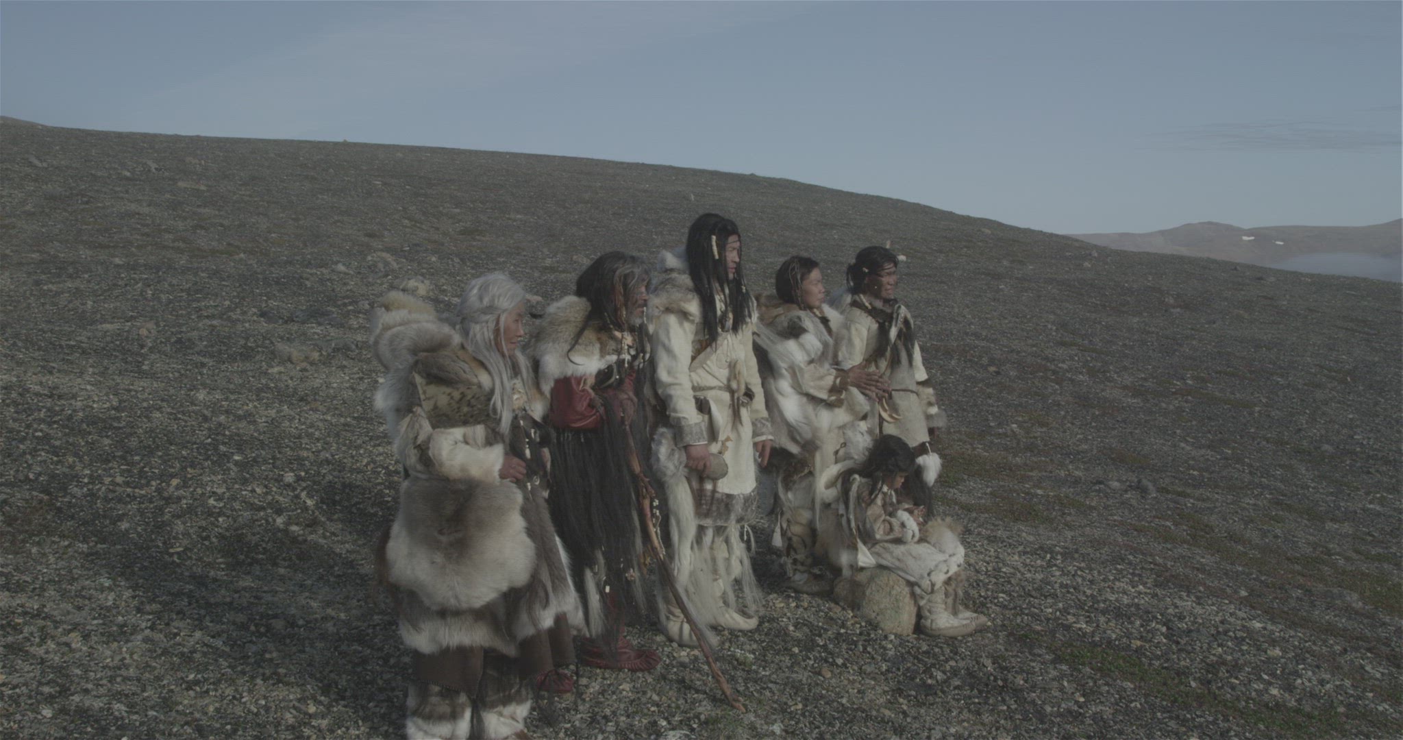 inuit samurai hunters walking on mountain ridge