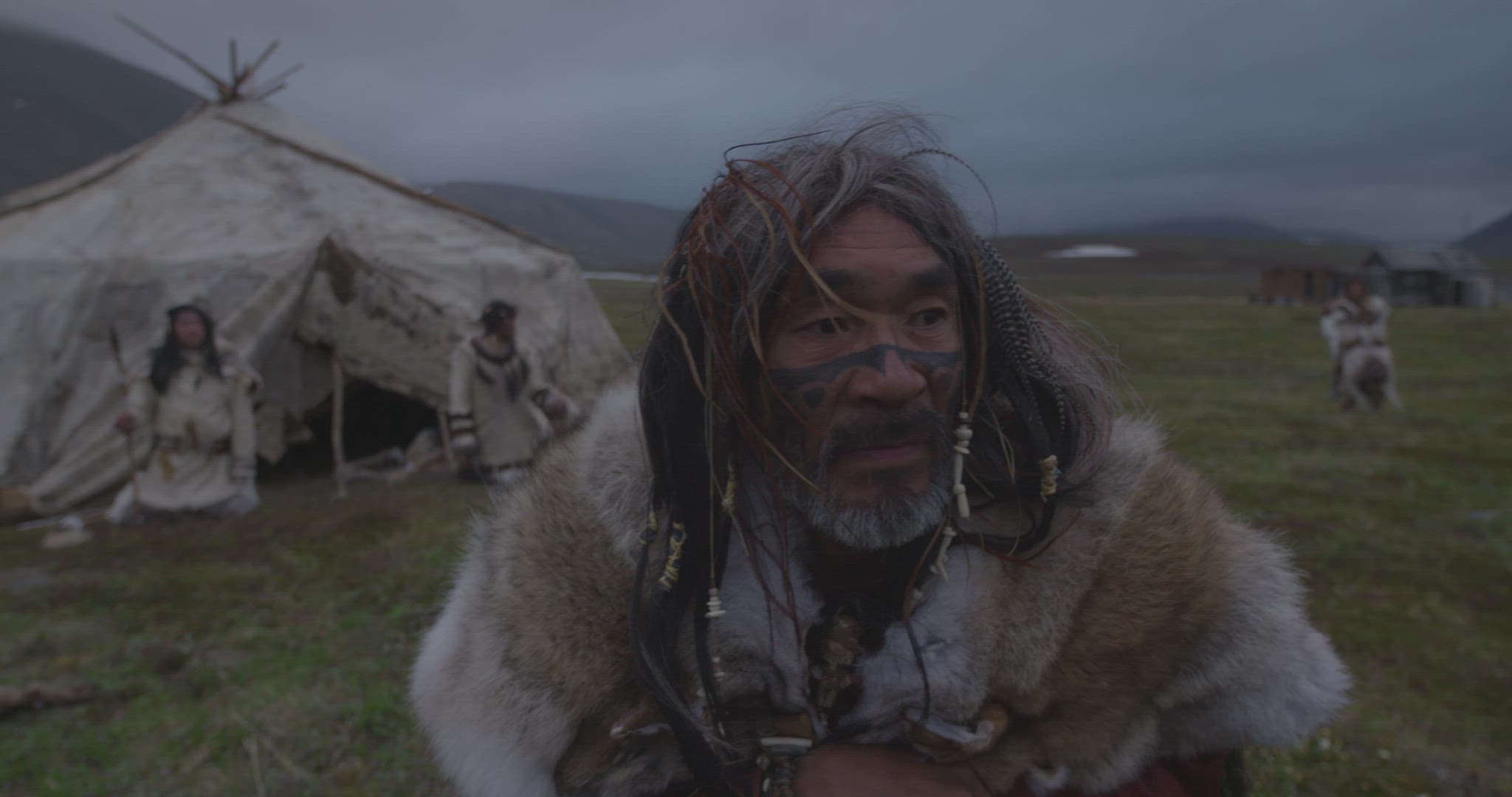 nomadic hunter outside hut