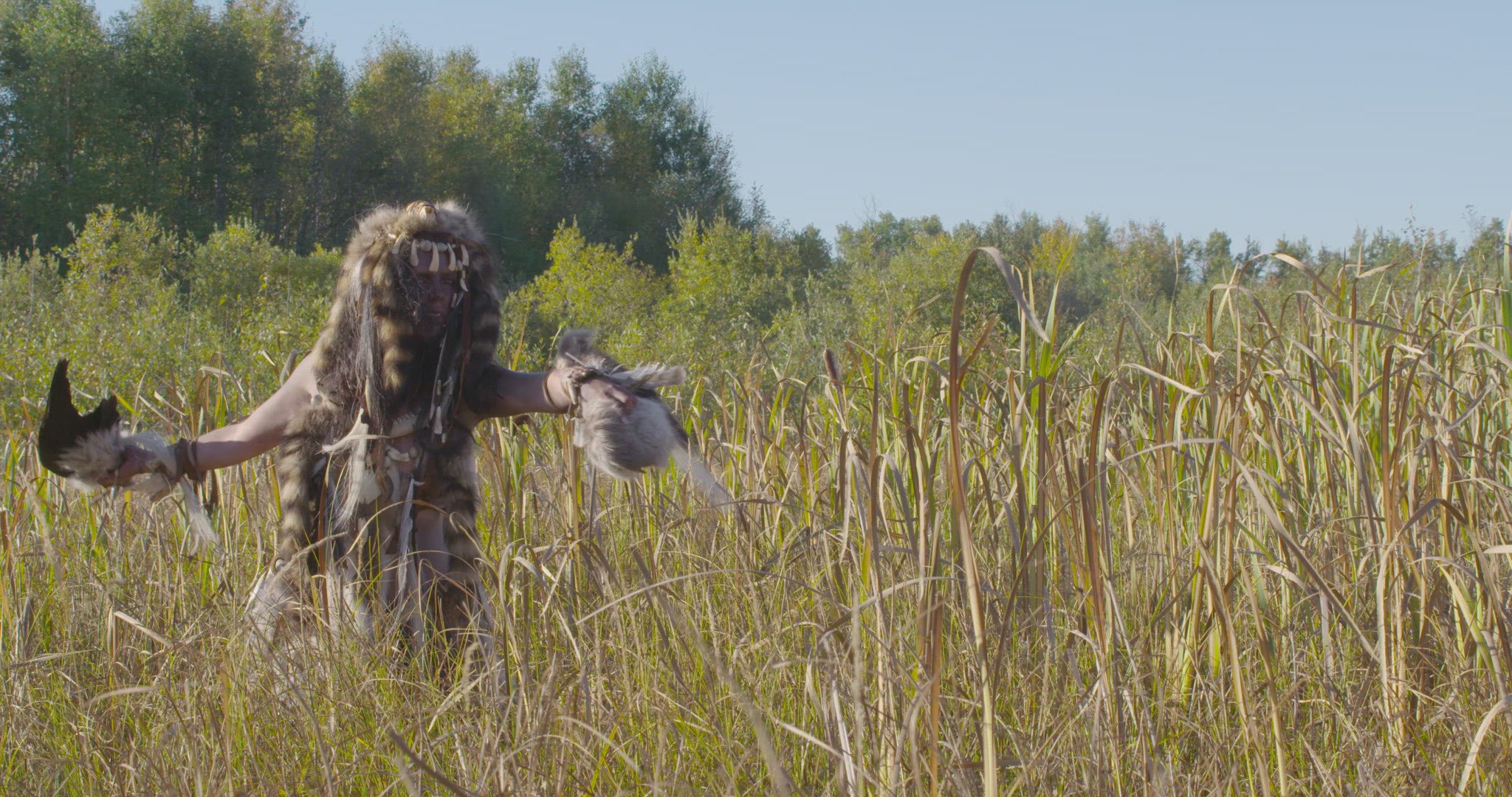 indigenous woman dancing in field
