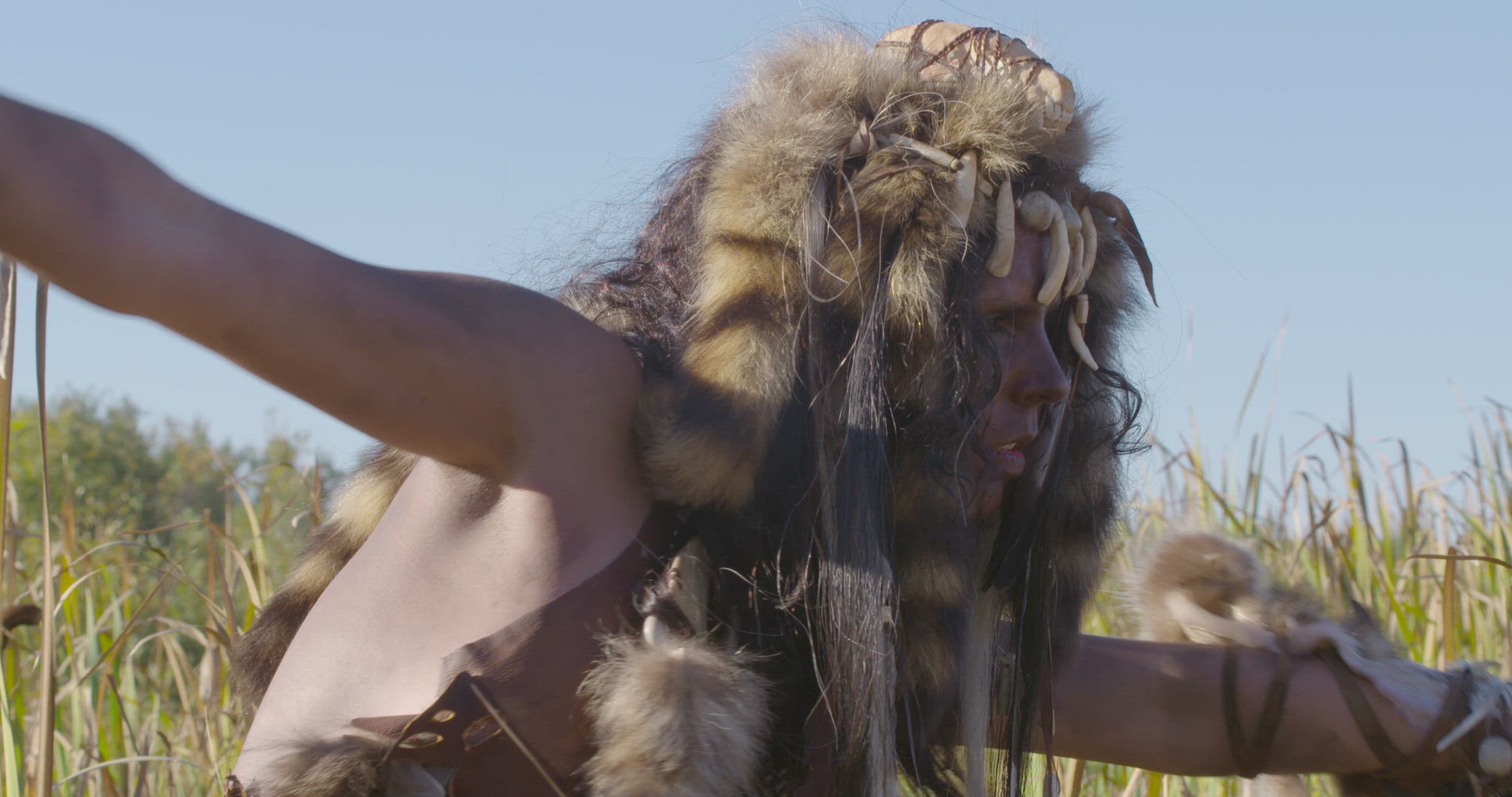 indigenous woman dancing in field