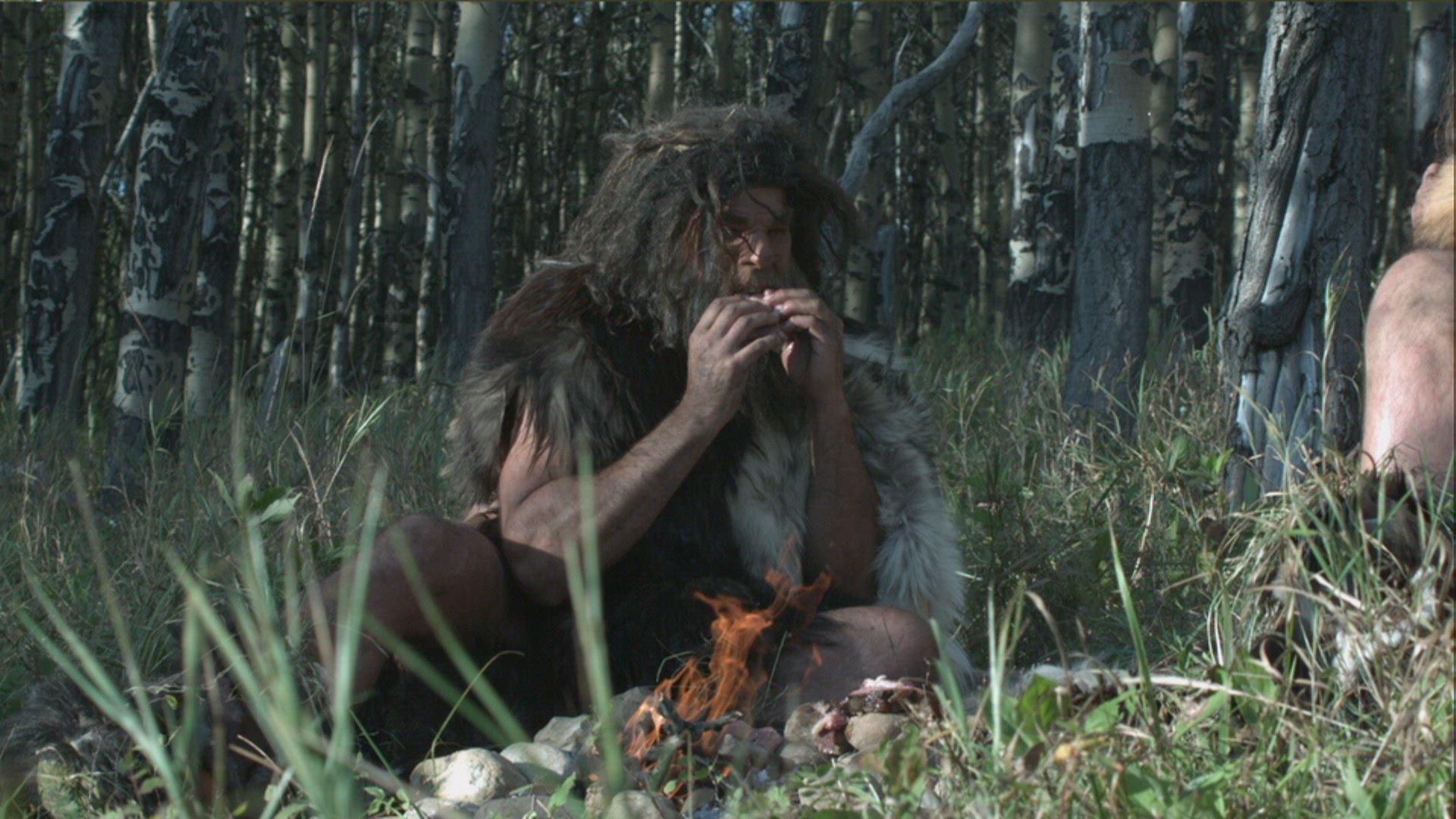 neanderthals eating meat by fire