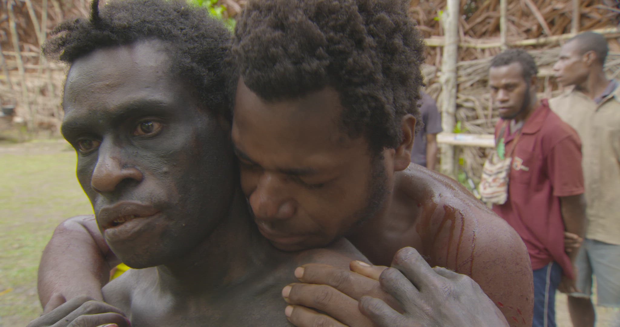 man being cleaned during male initiation ritual