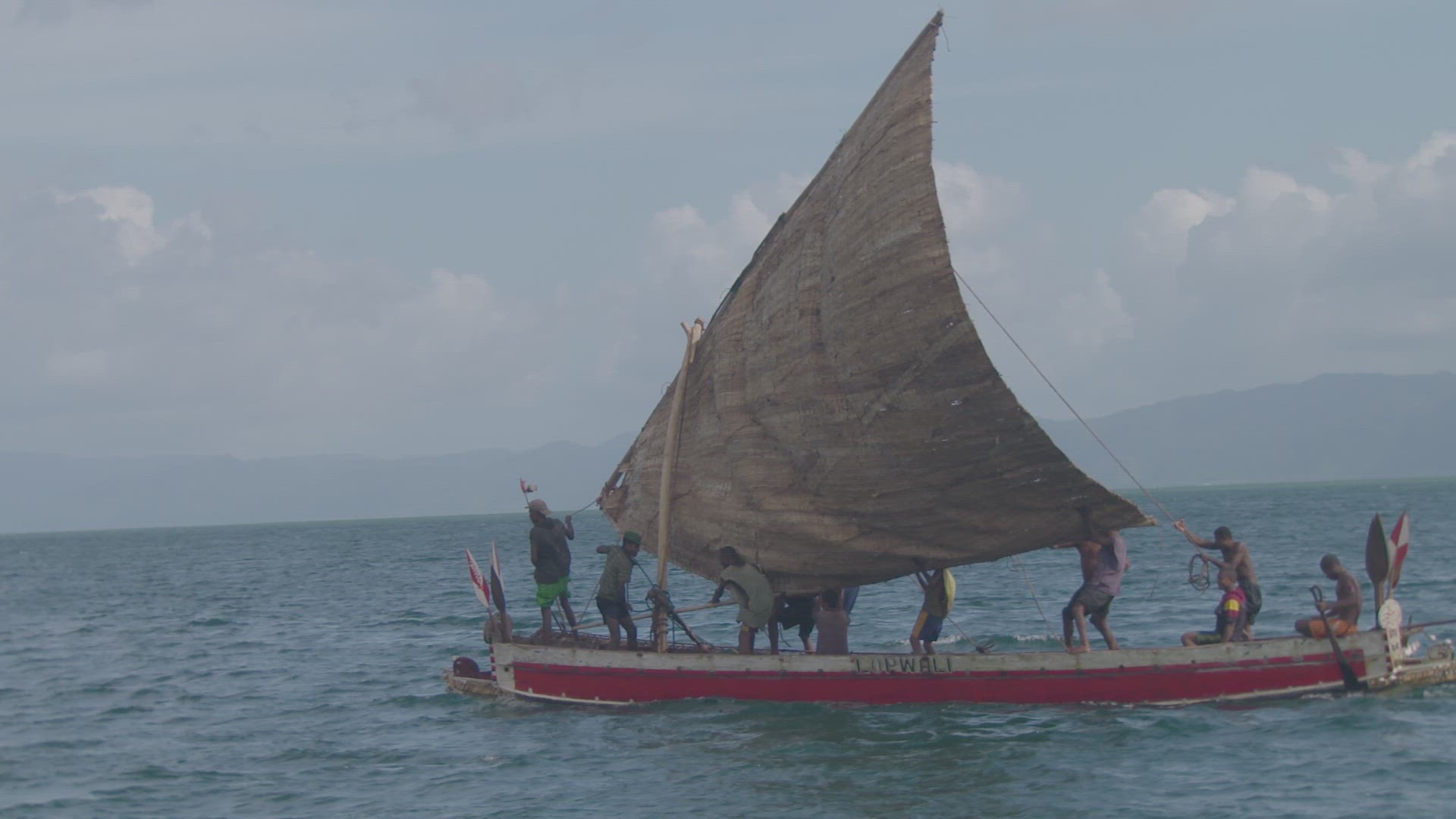 wooden war canoe on water