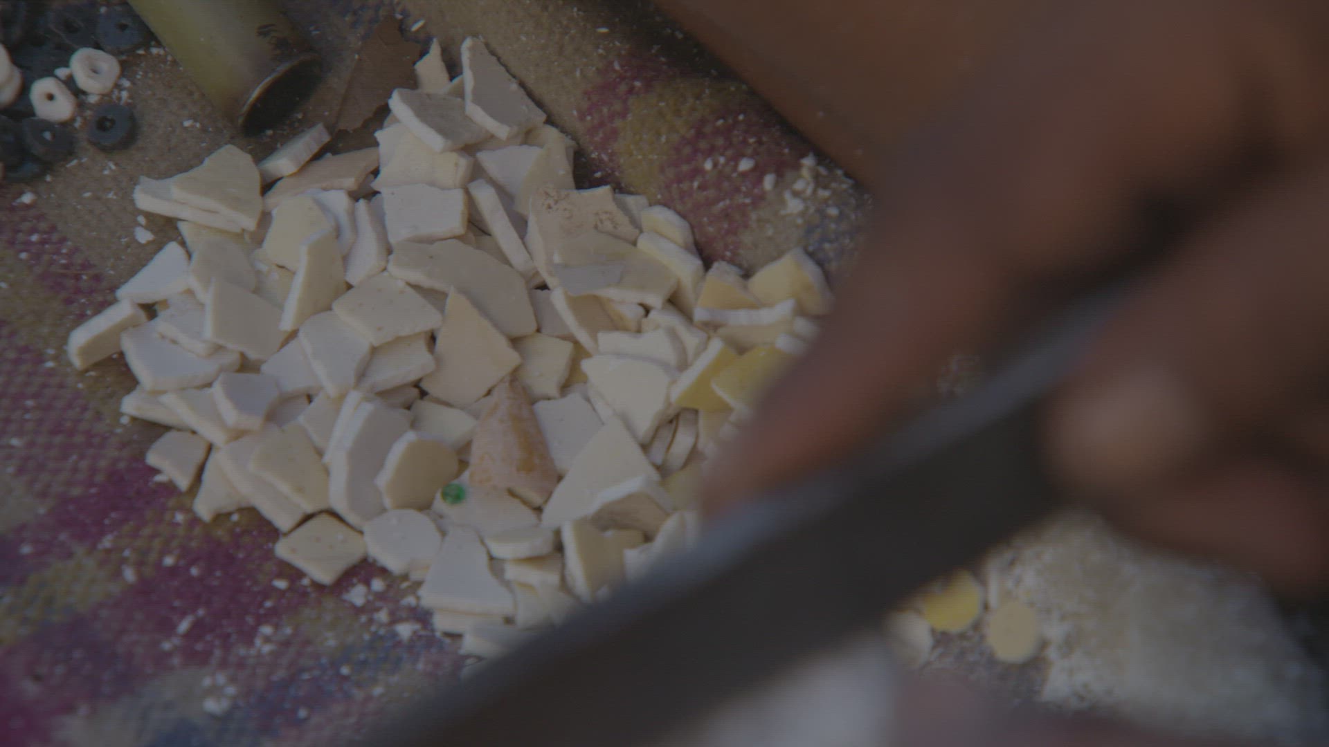 ostrich shell being formed into bead for jewelry