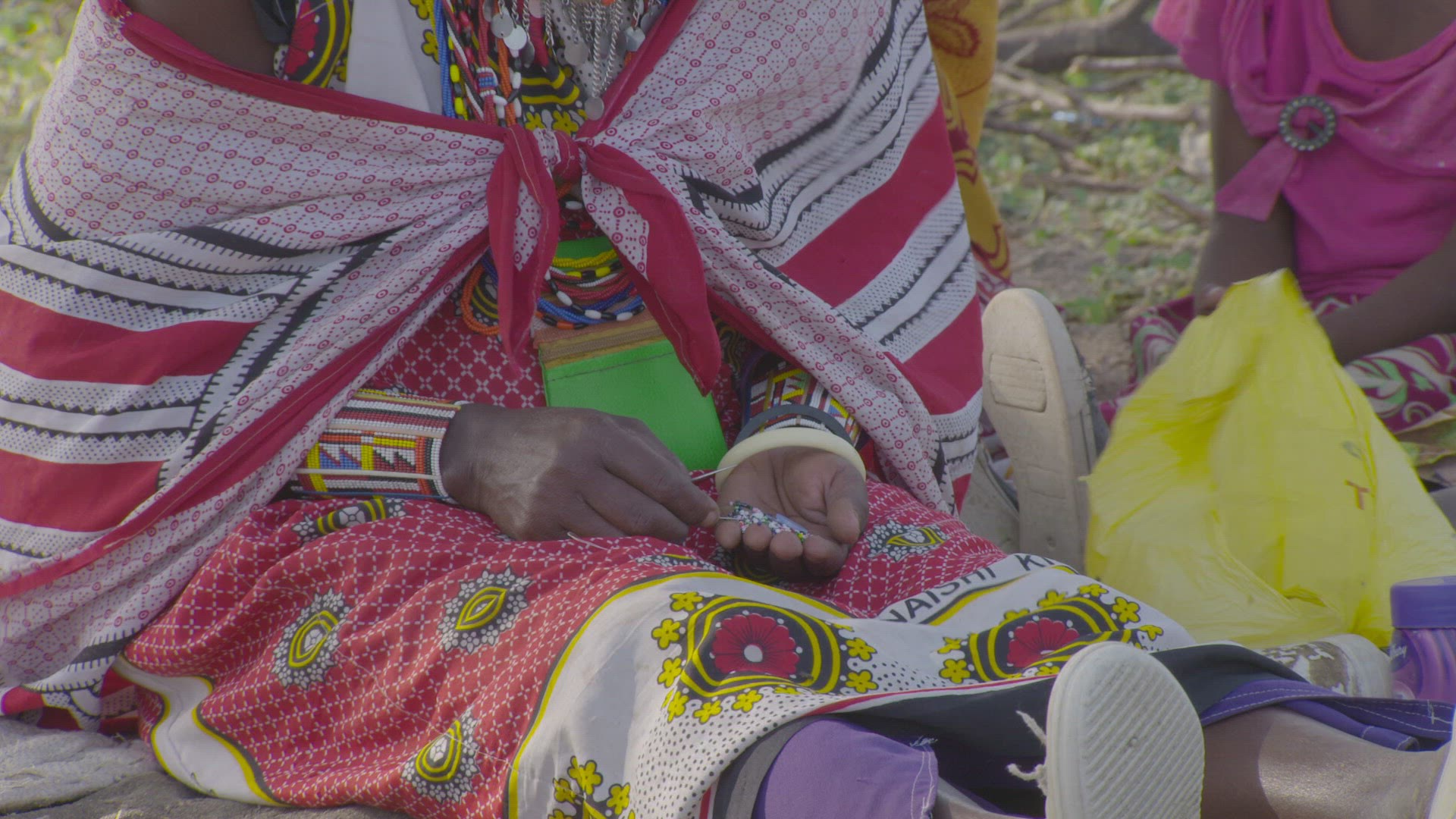 woman making beaded jewelry