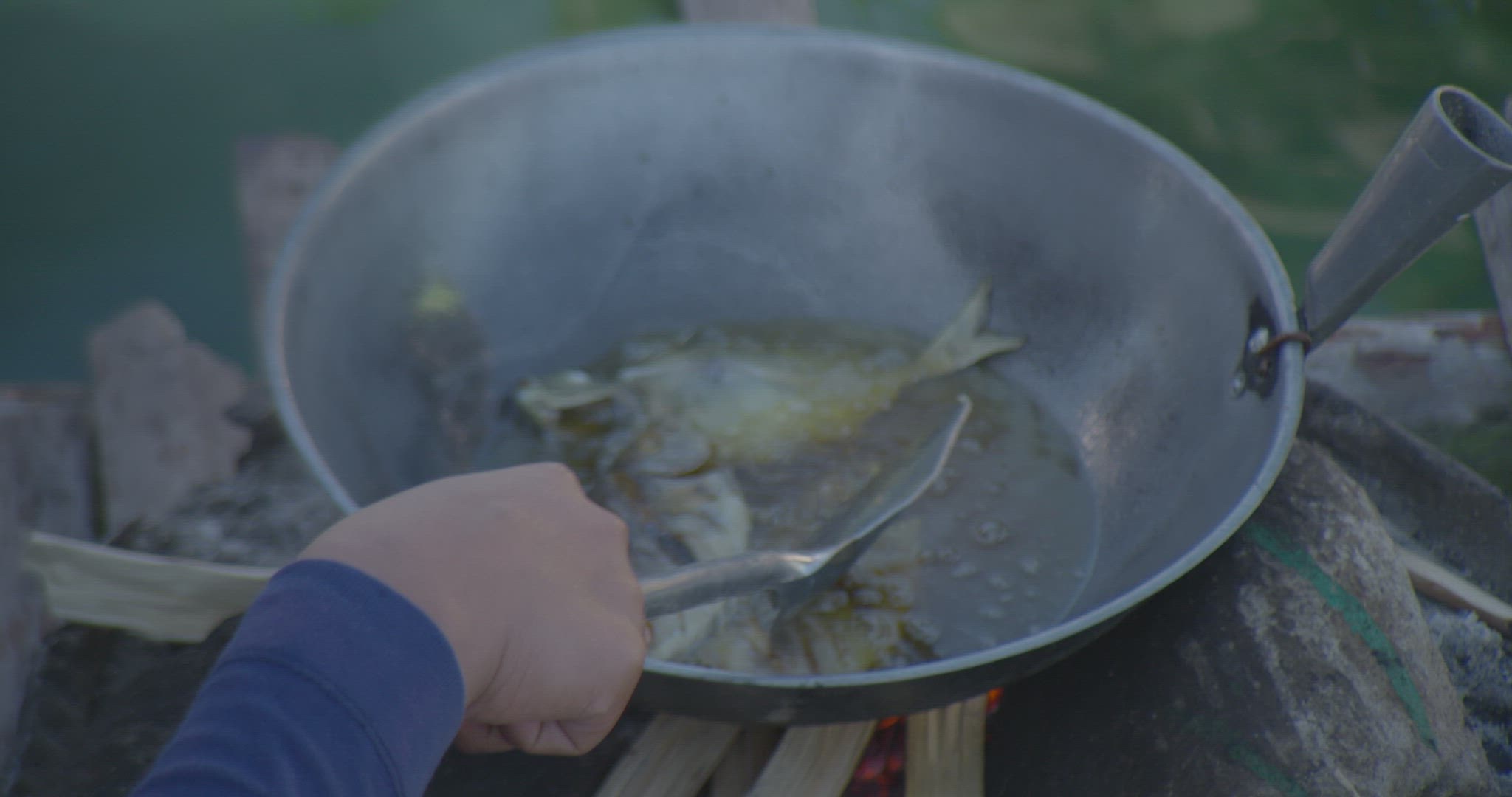 fish being fried in oil