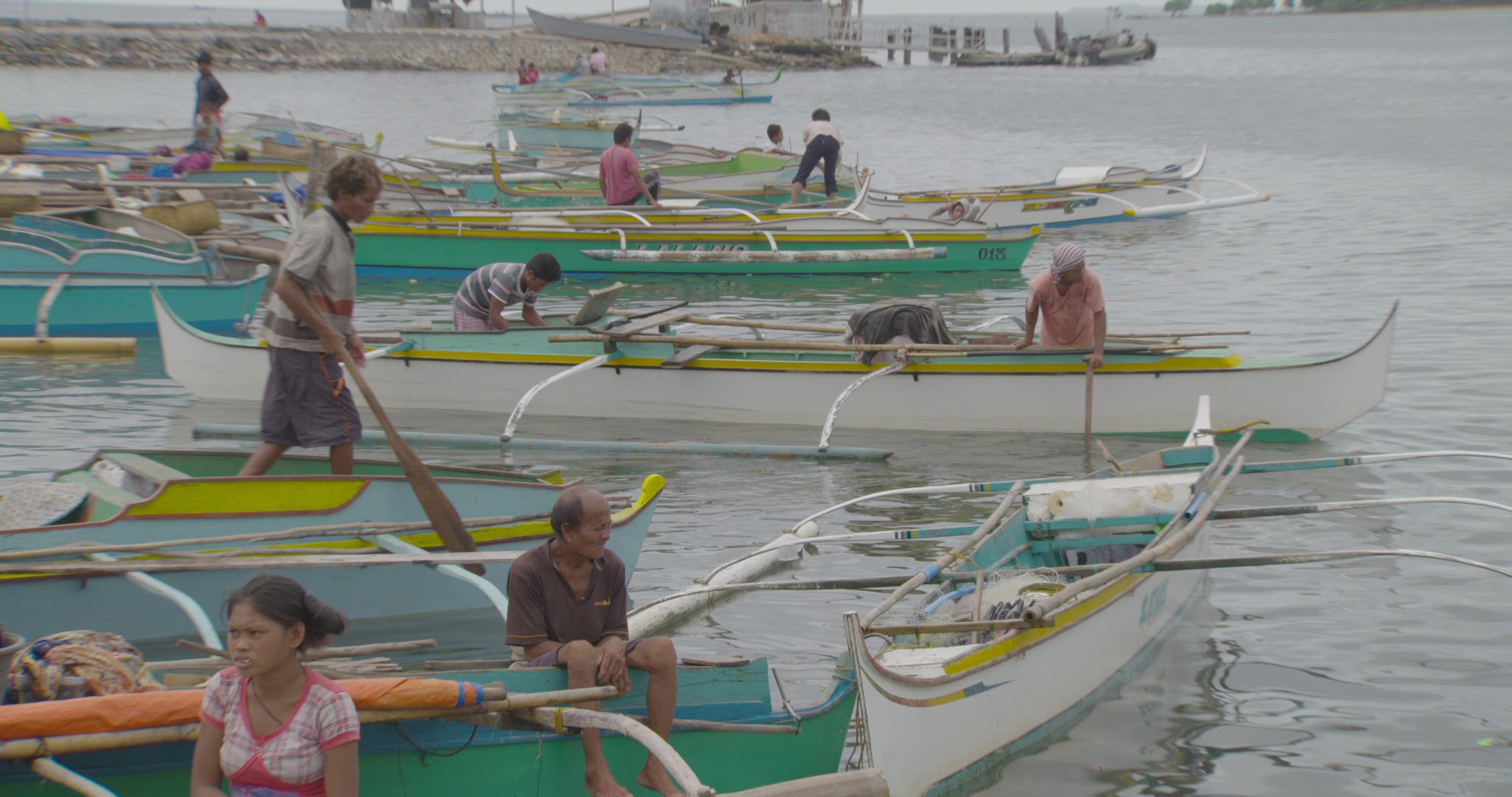 fishermen launching boat into water