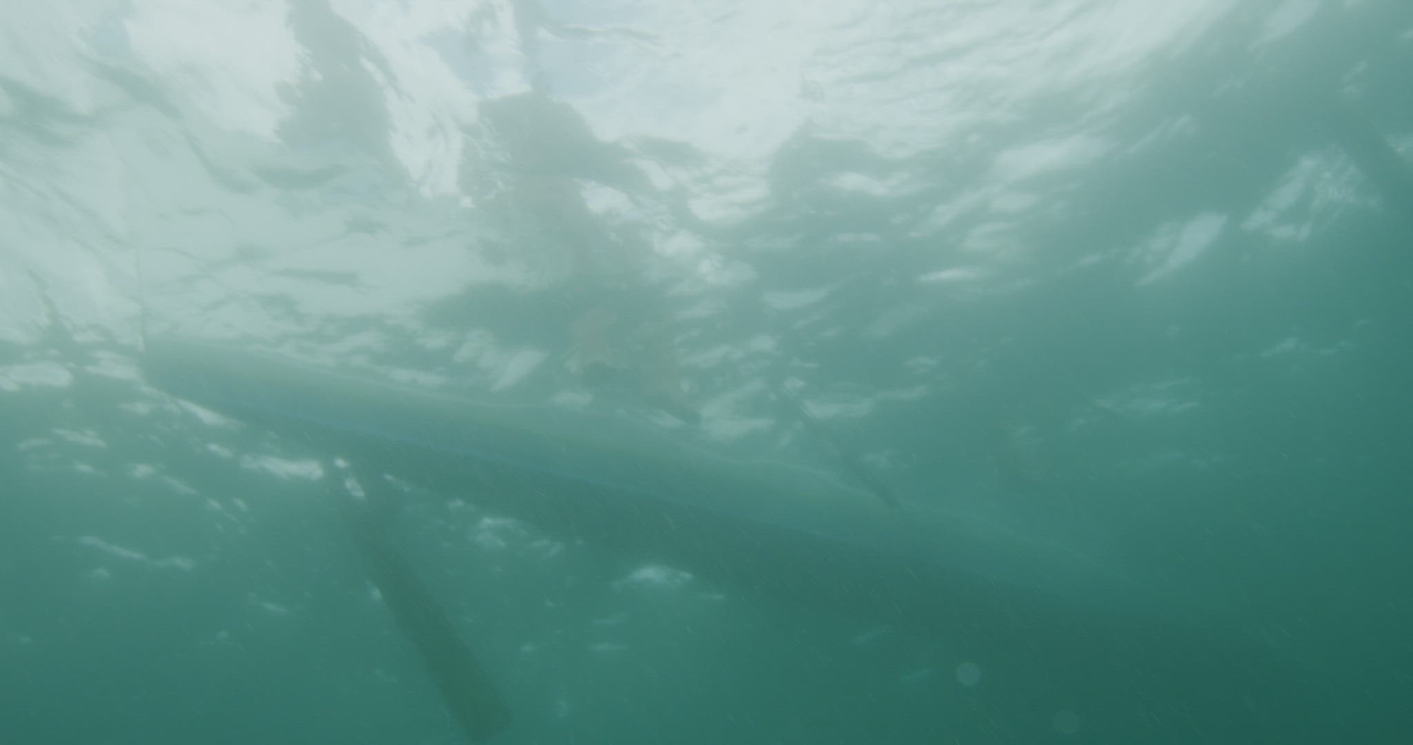 Filipino fishermen entering water from boat