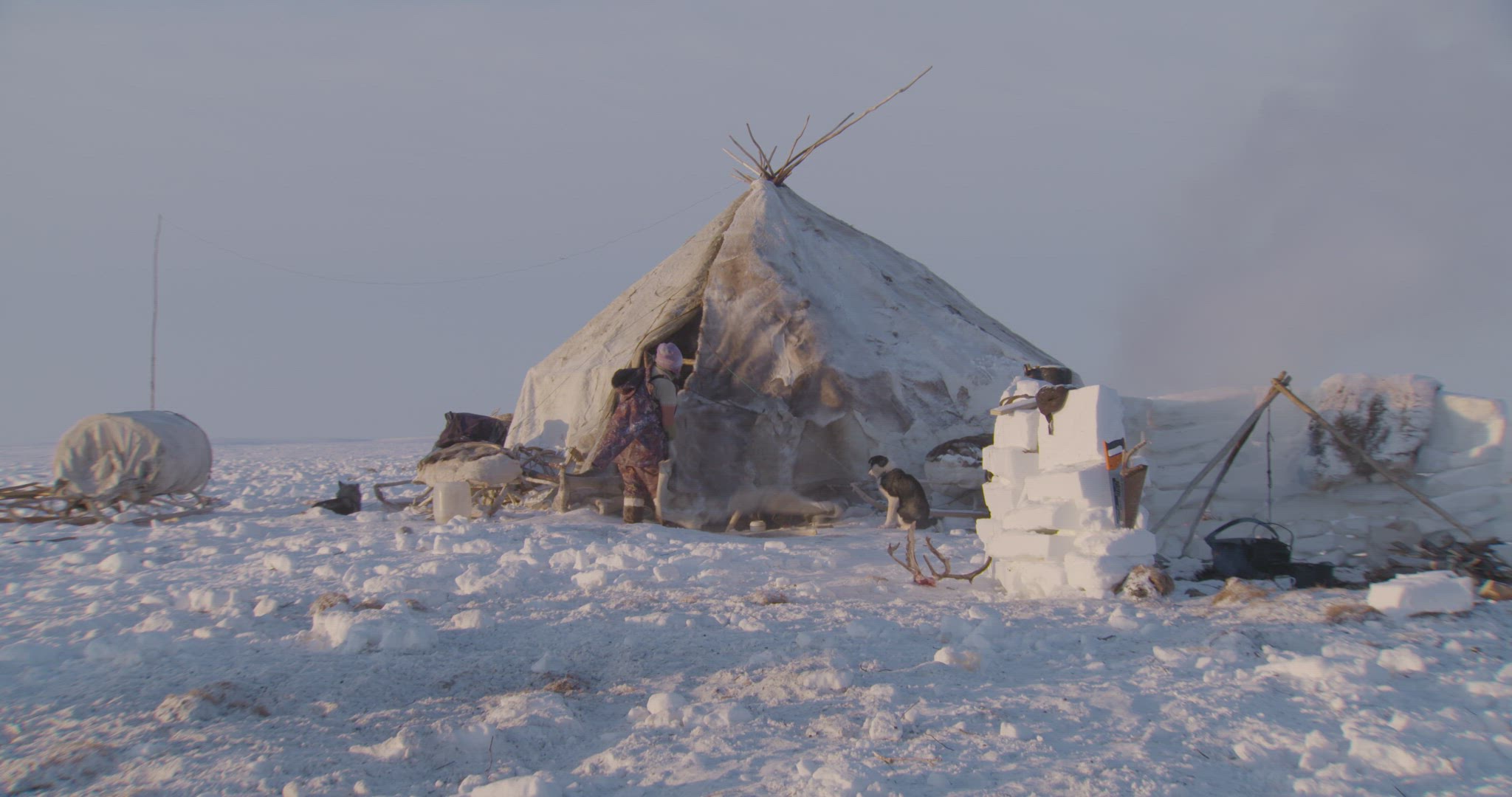 woman opening up yurt door