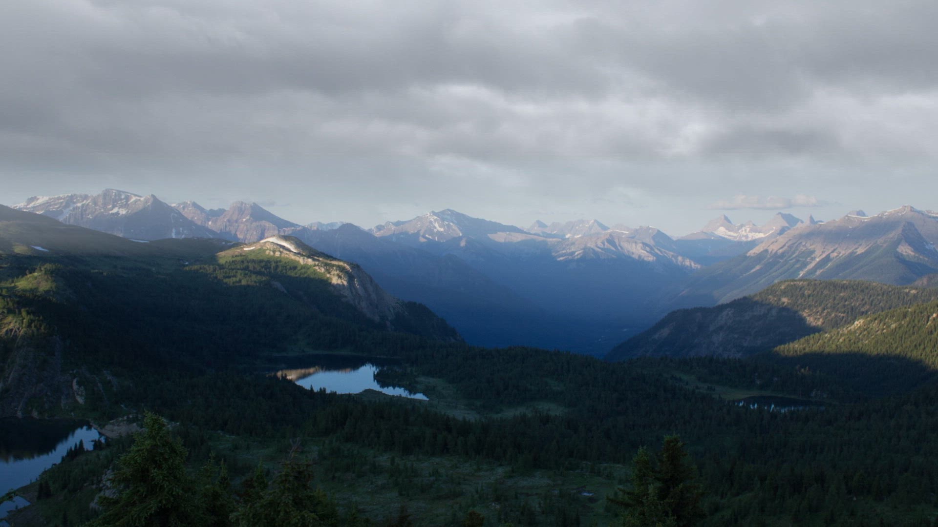 time-lapse of mountain valley being covered in snow in the winter time