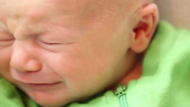 Crying Caucasian newborn baby