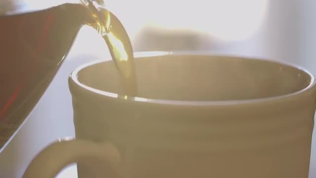 Close up of coffee pouring into cup