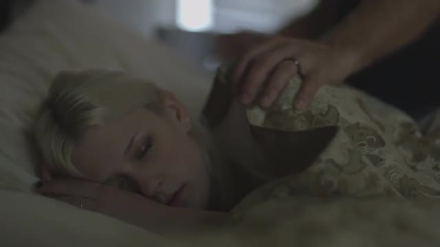 Caucasian man waking sleeping woman