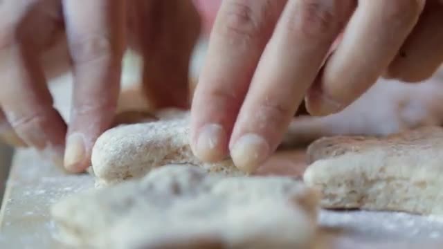 Hispanic woman pressing star shapes in dough